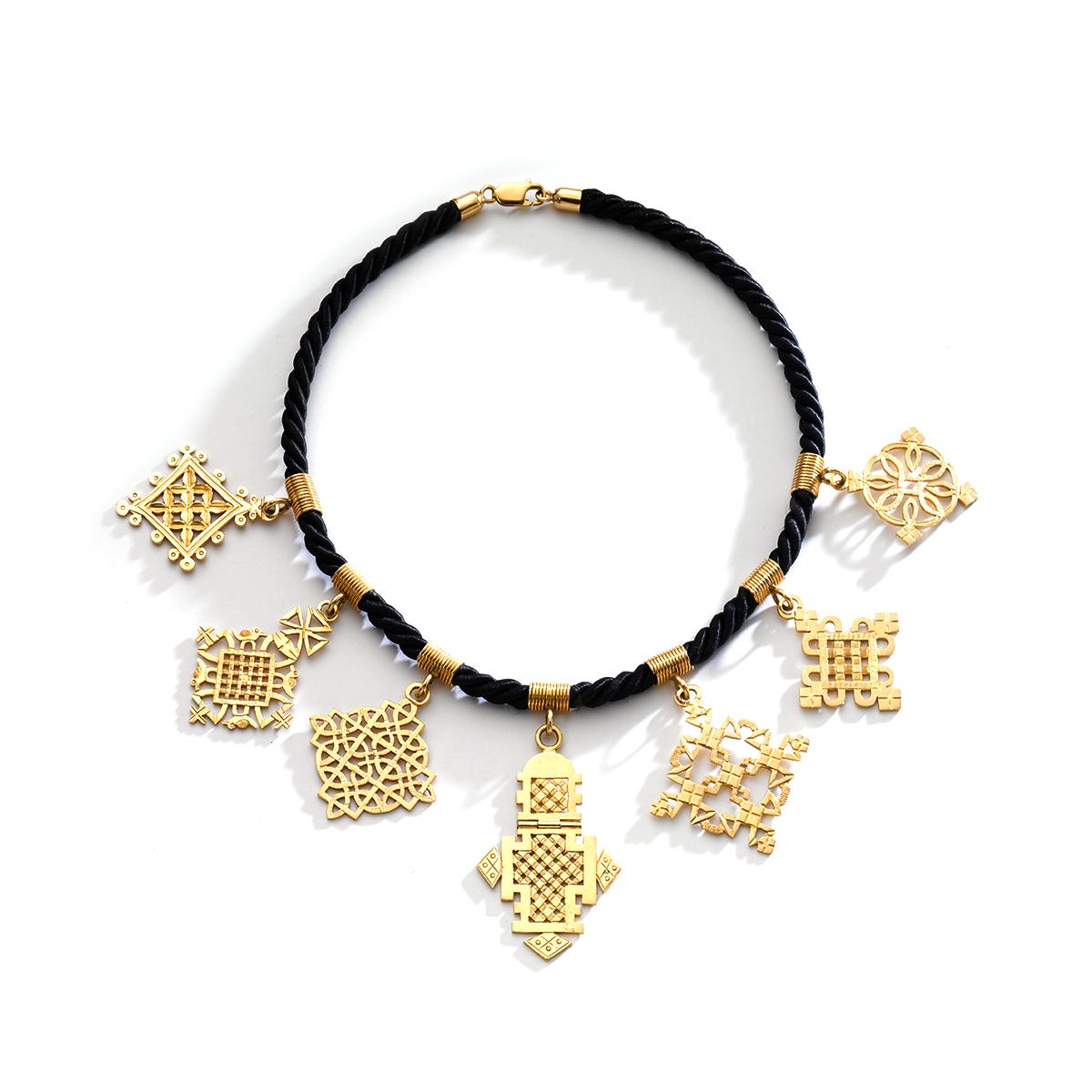 Seven Ethiopian Coptic Cross yellow gold 18k Pendants Necklace. Each Pendant is attached to a black cord with yellow gold clasp.

Total length: 15.75 inches (40.00 centimeters).
Pendants total height: from 1.57 to 2.56 inches 
(4.00 to 6.50