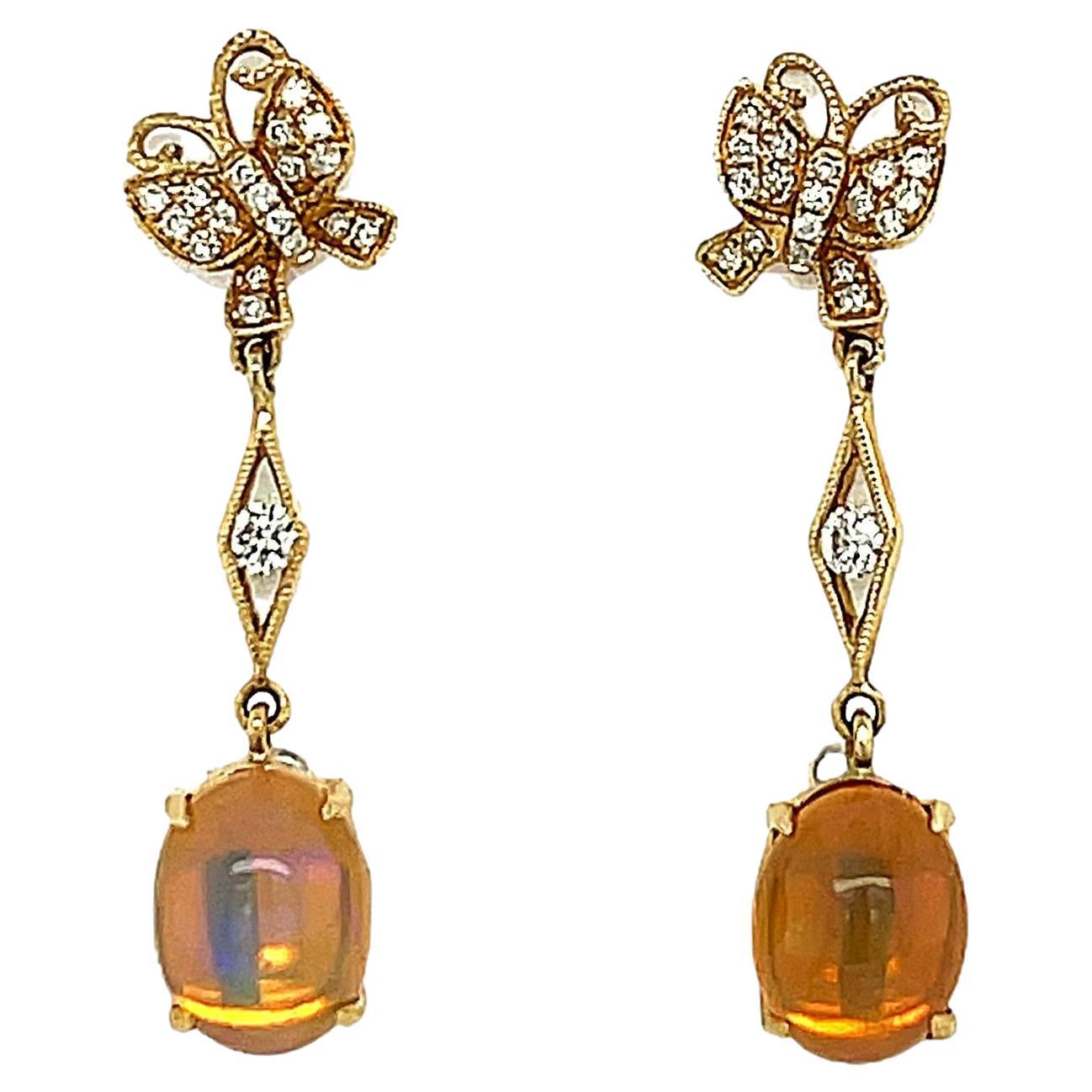These stunning Ethiopian Opal and diamond dangling earrings are 4 prong set in 14 karat white gold. There are sparkling diamonds scattered throughout for a beautiful accent. These earrings are approximately 1.25
