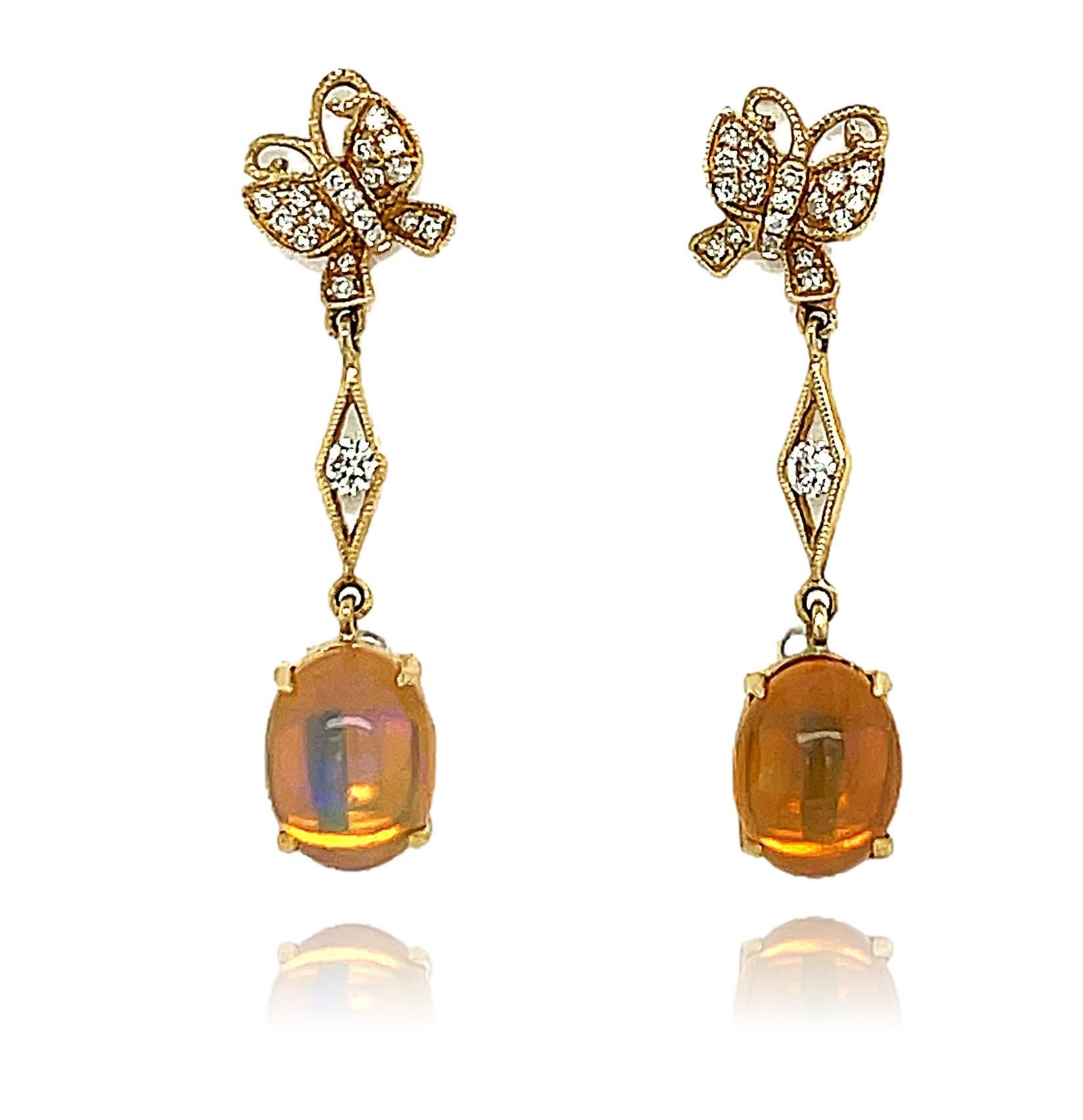 These stunning Ethiopian Opal and diamond dangling earrings are 4 prong set in 14 karat yellow gold. There are sparkling diamonds scattered throughout for a beautiful accent. These earrings are approximately 1.25
