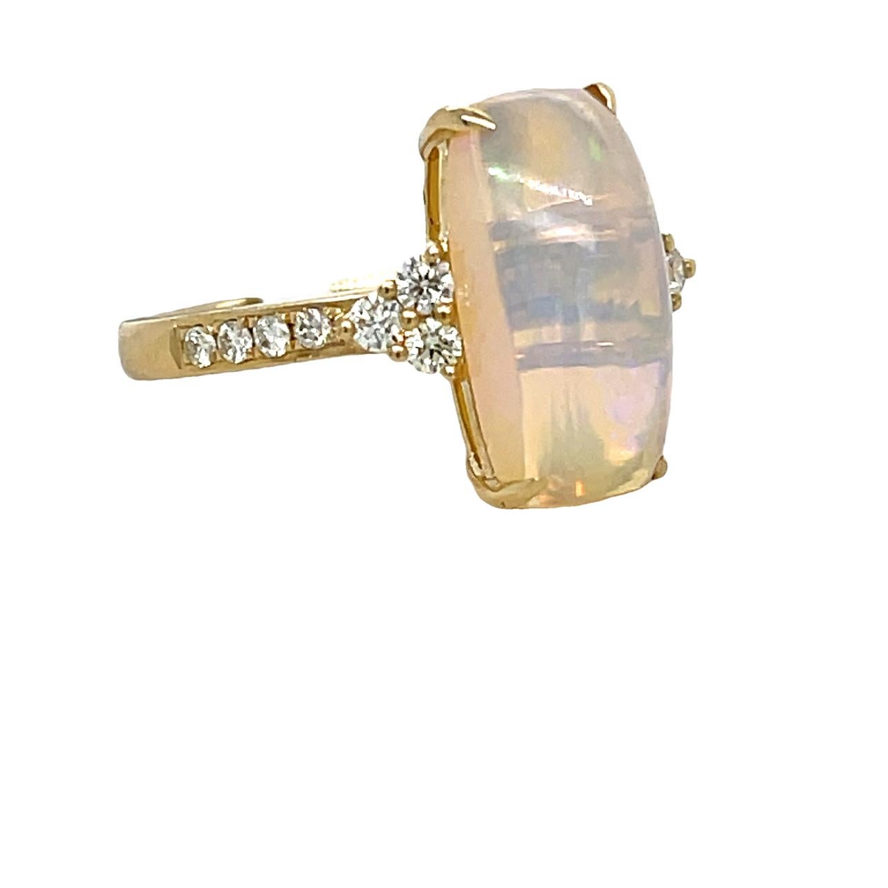 This stunning ring has a 14.5x7.5 vibrant Ethiopian Opal with 14 brilliant cut round diamonds on the side and along the shank. The Opal is 4 prong set in 14K yellow gold. This beautiful ring will be the talk of your special event. This ring will be