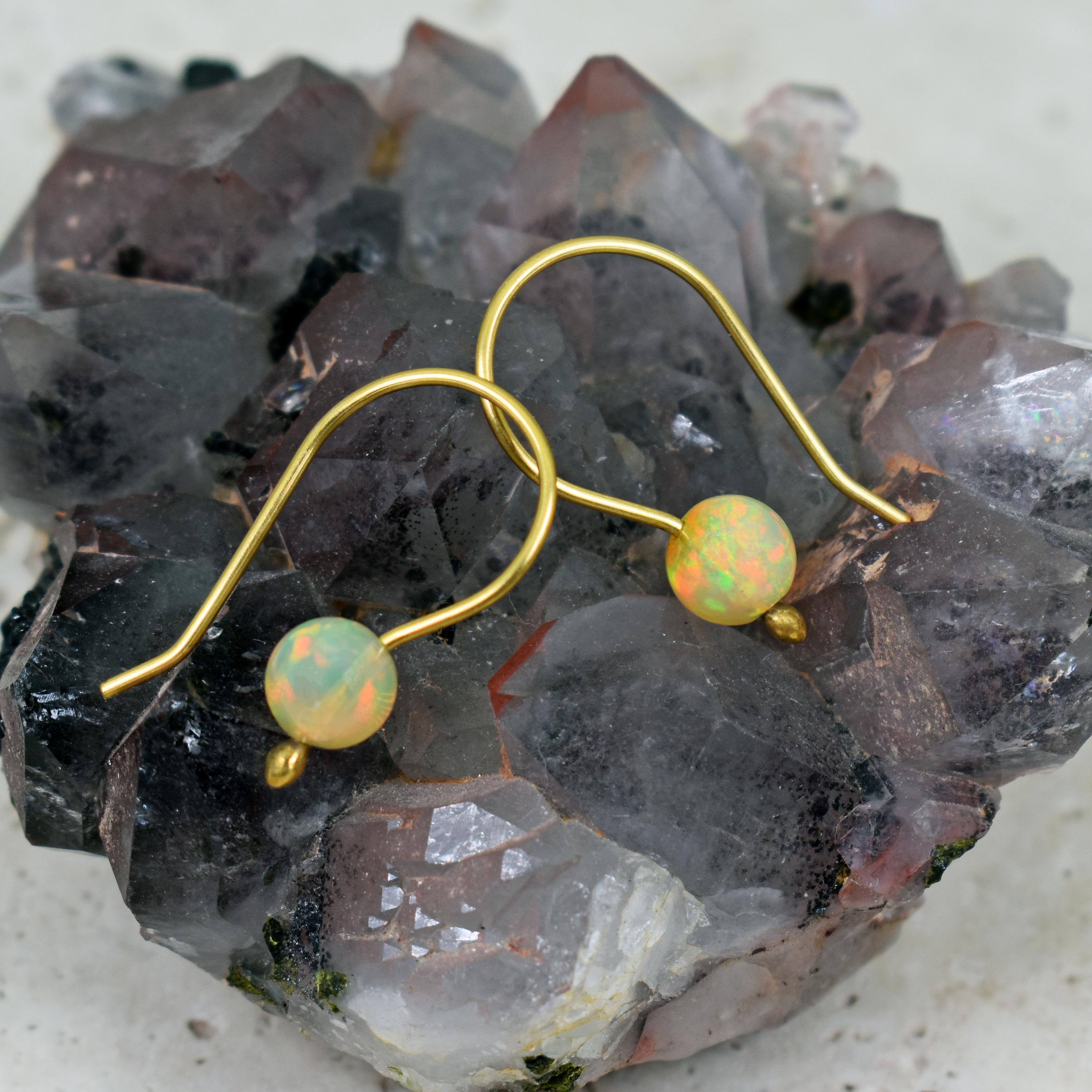 Gorgeous Ethiopian Opal bead 18k yellow gold wire drop earrings. Drop earrings are 1 inch in length. Beautiful, fiery Opals in this minimal style earring makes this pair lightweight and very wearable.
