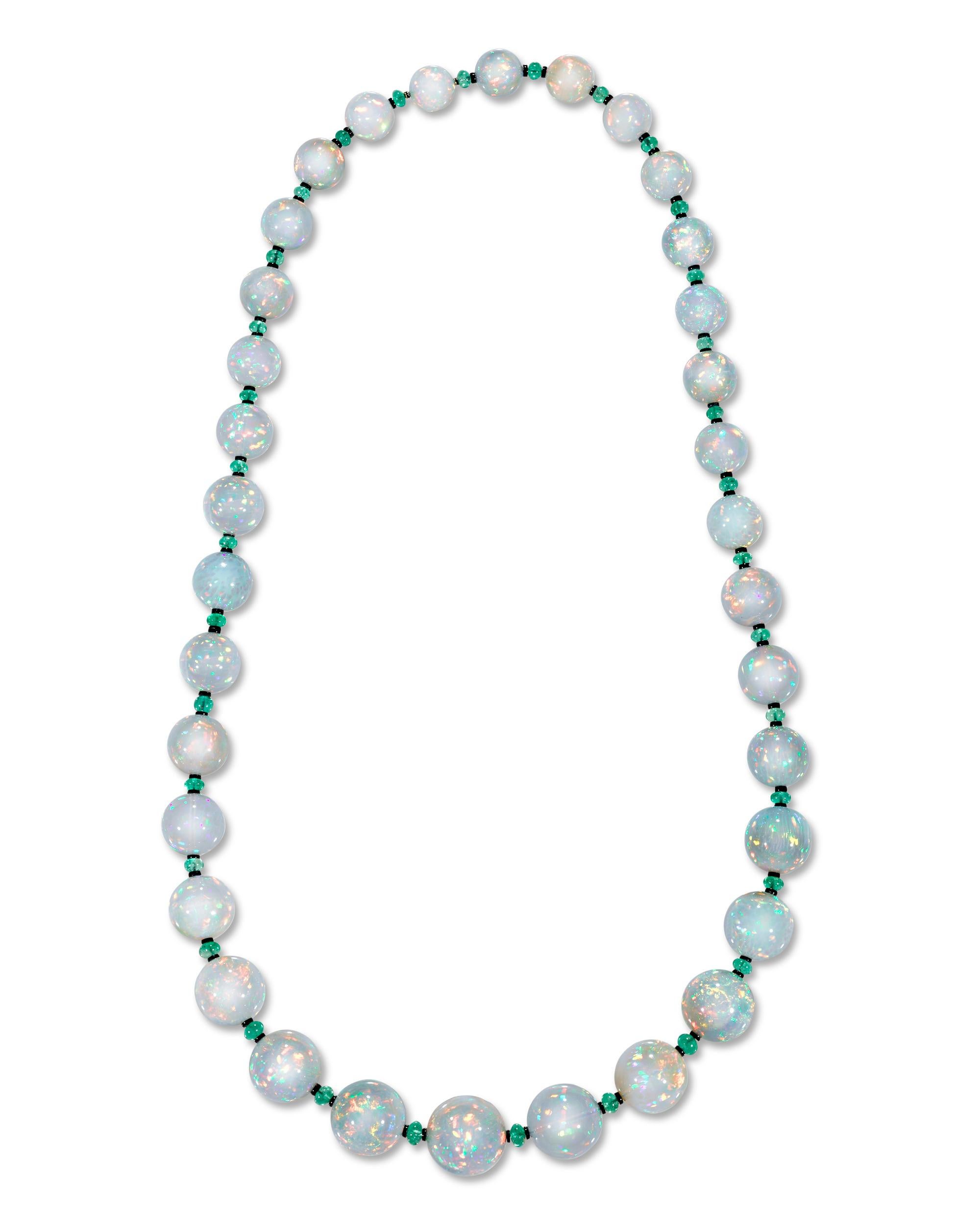 Thirty-four solid opal beads totaling approximately 680.00 carats line the length of this eye-catching necklace. The graduated gems are an impressive size and perfectly matched, with each exhibiting a high level of translucence and a rainbow of