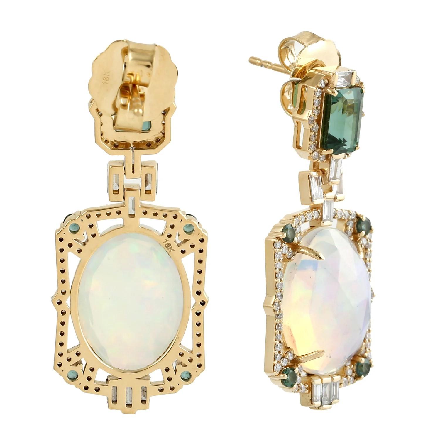Handcrafted from 18-karat gold, these exquisite drop earrings are set with 10.03 carats Ethiopian Opal, 2.91 carats green tourmaline and 1.15 carats of glimmering diamonds. 

FOLLOW  MEGHNA JEWELS storefront to view the latest collection & exclusive