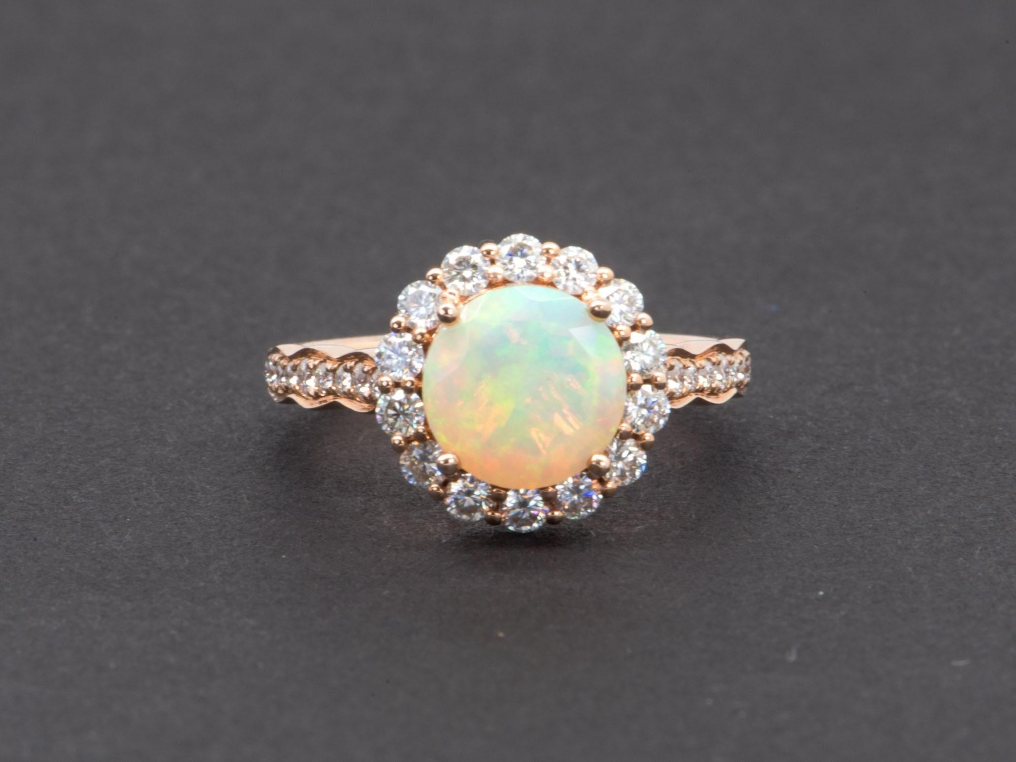 ♥ Solid 14K gold ring set with a beautiful round Ethiopian opal in the center, flanked by a halo of bright white moissanites. The shank is also decorated with gradual-sized moissanites for maximum sparkle!
♥ The opal is incredibly fiery with a