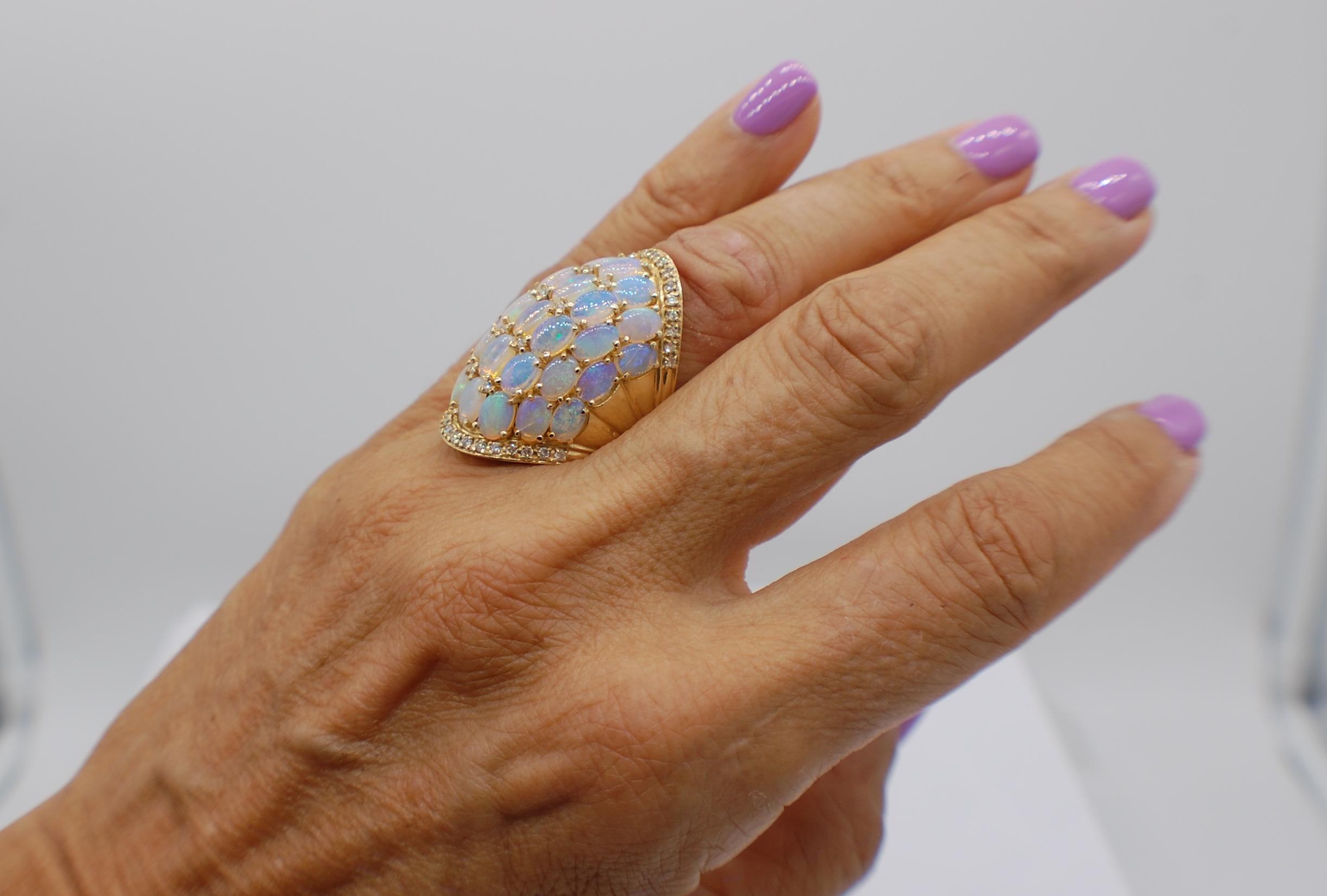 Opal Cluster and Diamond Dome Ring is set in 14 Karat yellow gold. The ring features a wonderful design encompassing beautiful gemstones in a wide & tall dramatic dome. 
The ring measures 1.40 inches tall by .84 