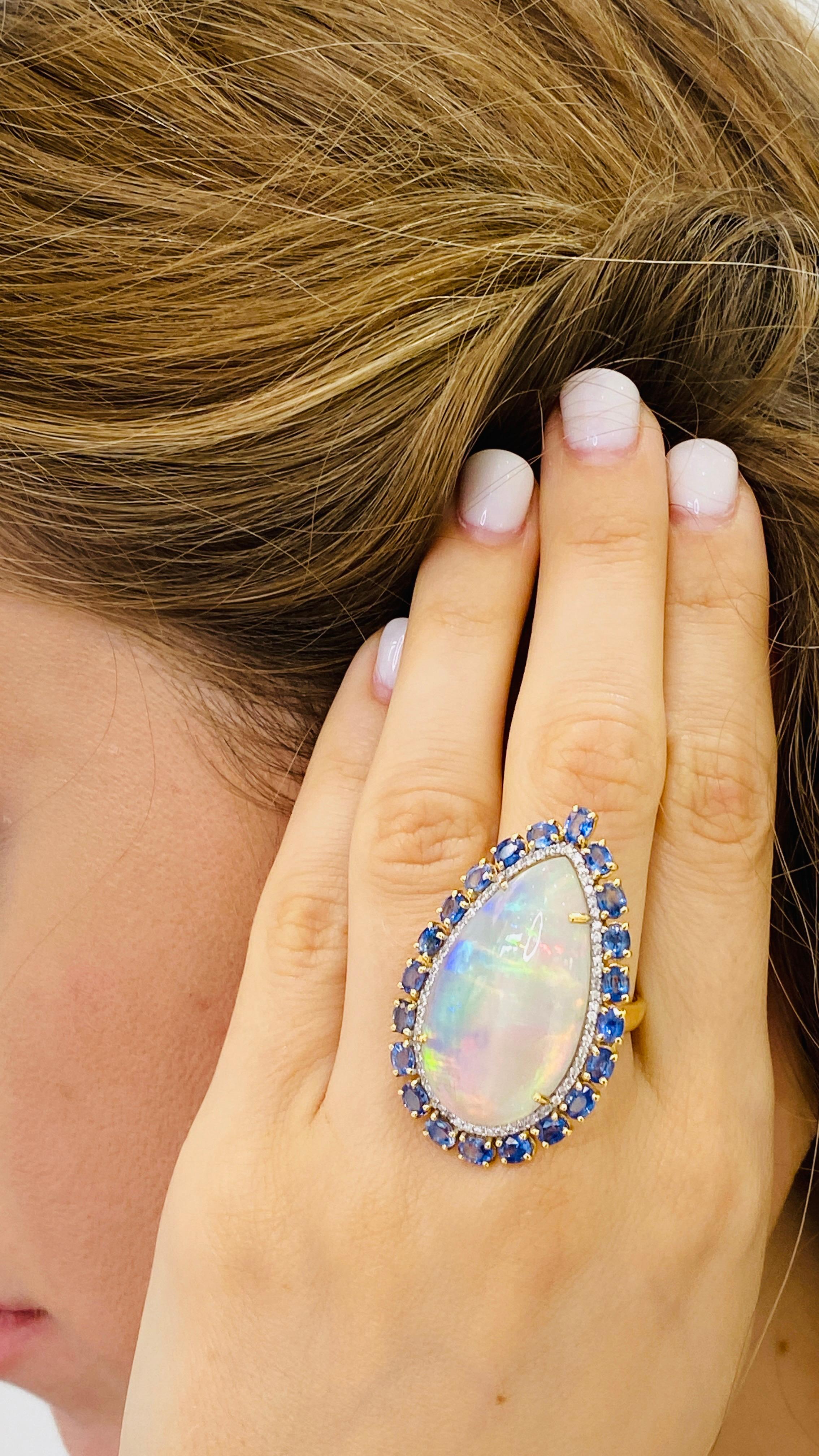Contemporary Ethiopian Opal Pear Shape, Blue Sapphire & Diamond Ring In 18K Yellow Gold For Sale