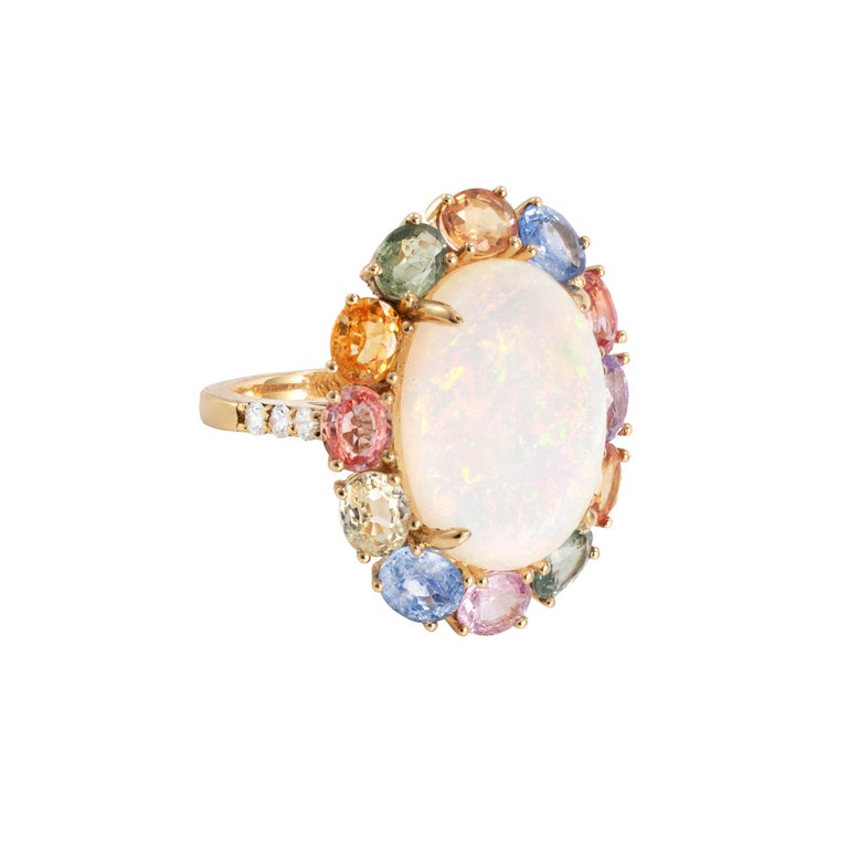 Sunita Nahata presents an exquisite Ethiopian Opal cabochon ring accented with rainbow sapphires and dazzling diamonds to accentuate the fire and sparkle within this colorful opal. The gorgeous and colorful gems on this ring will grab every