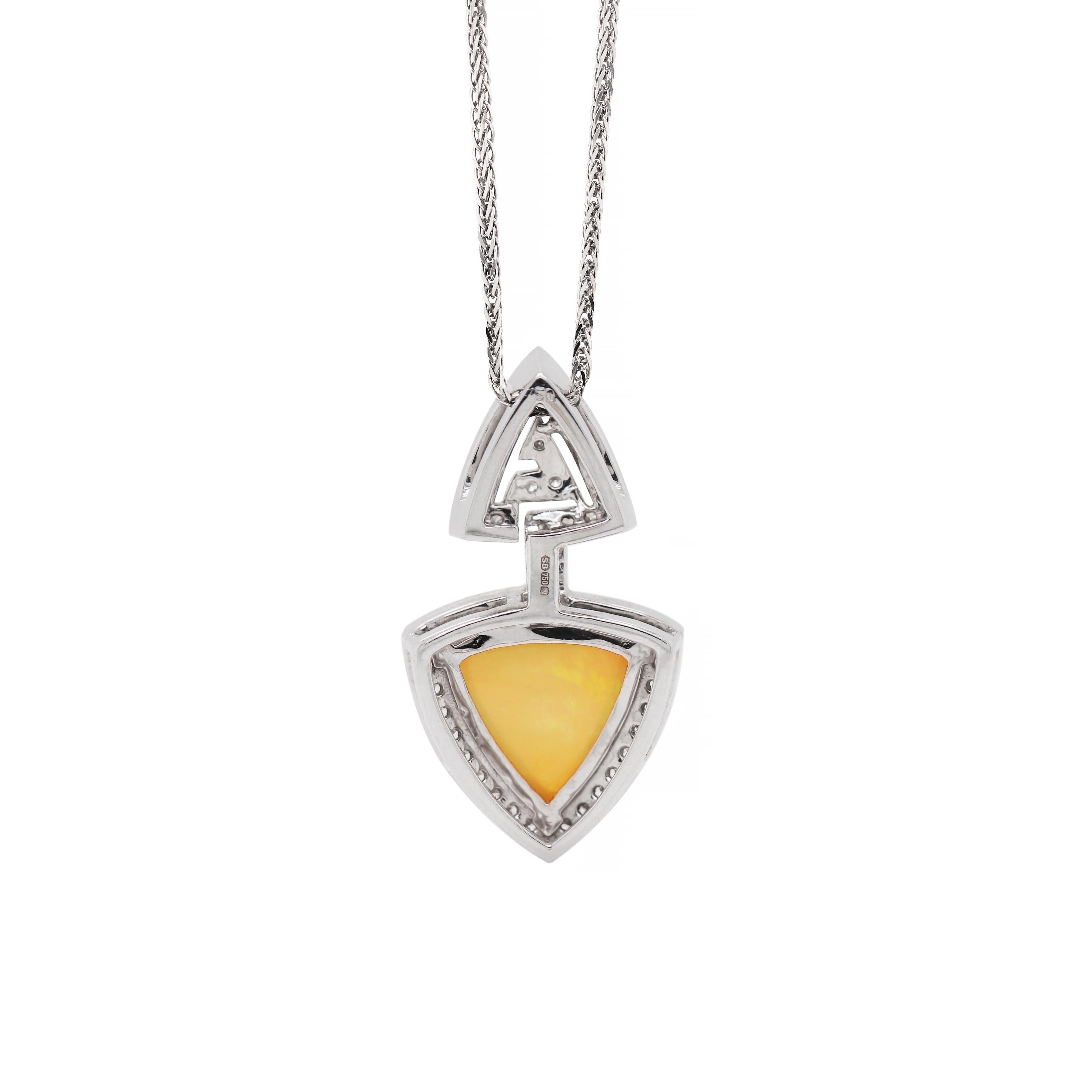 This unique necklace features a lovely triangle Ethiopian cabochon opal with a beautiful play of colour weighing approximately 4.25ct mounted in a three claw open back setting. This remarkable stone sits within a geometric triangular arrow designed