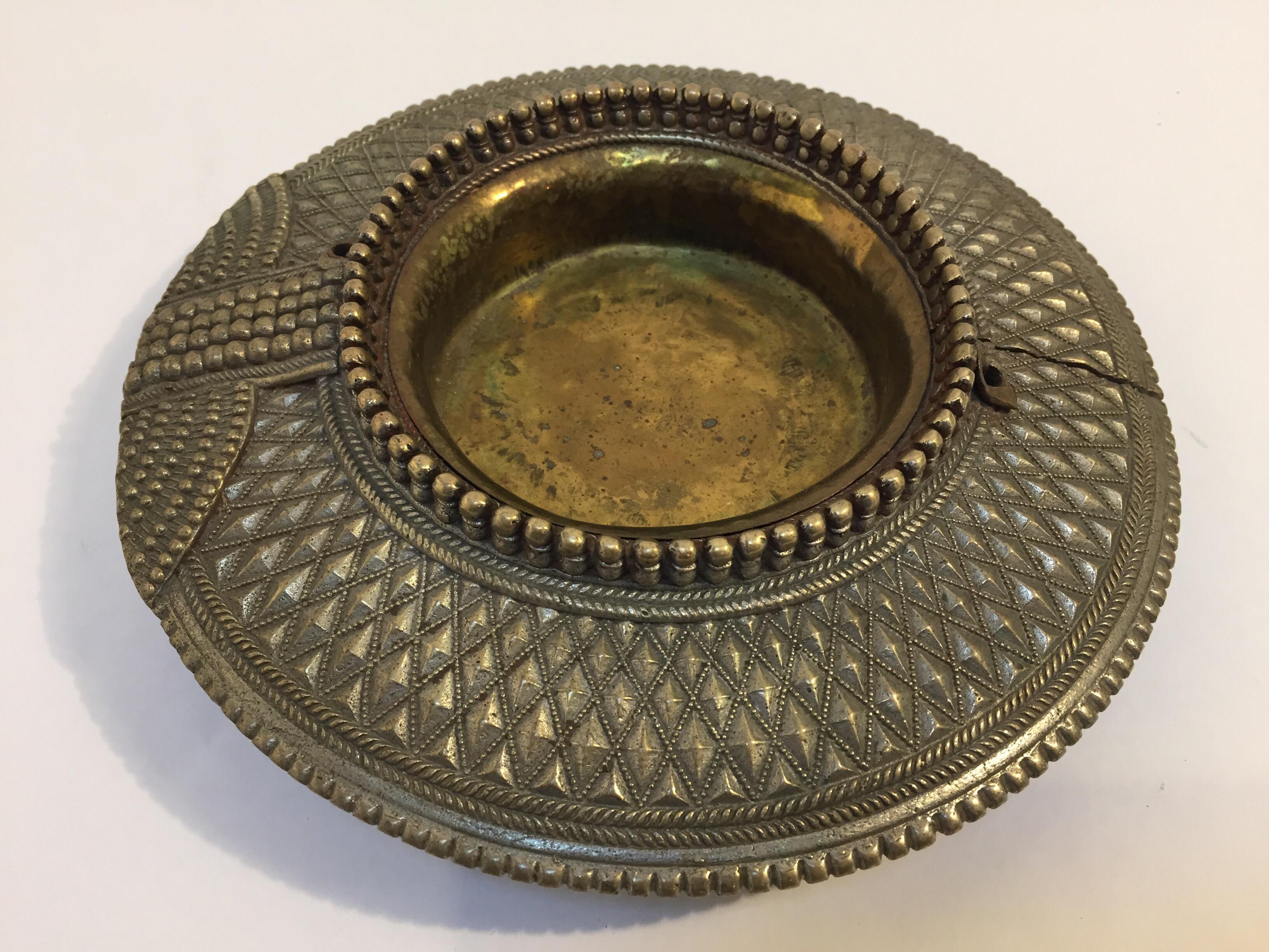 Dhokra art old ethnic tribal brass traditional ankle bracelet from India, repurposed as ashtrays ,catchall, or vide poche. 
Handcrafted of a hollow band of heavy brass decorated with chevron repoussé banding and lost wax granulation.
The brass inner