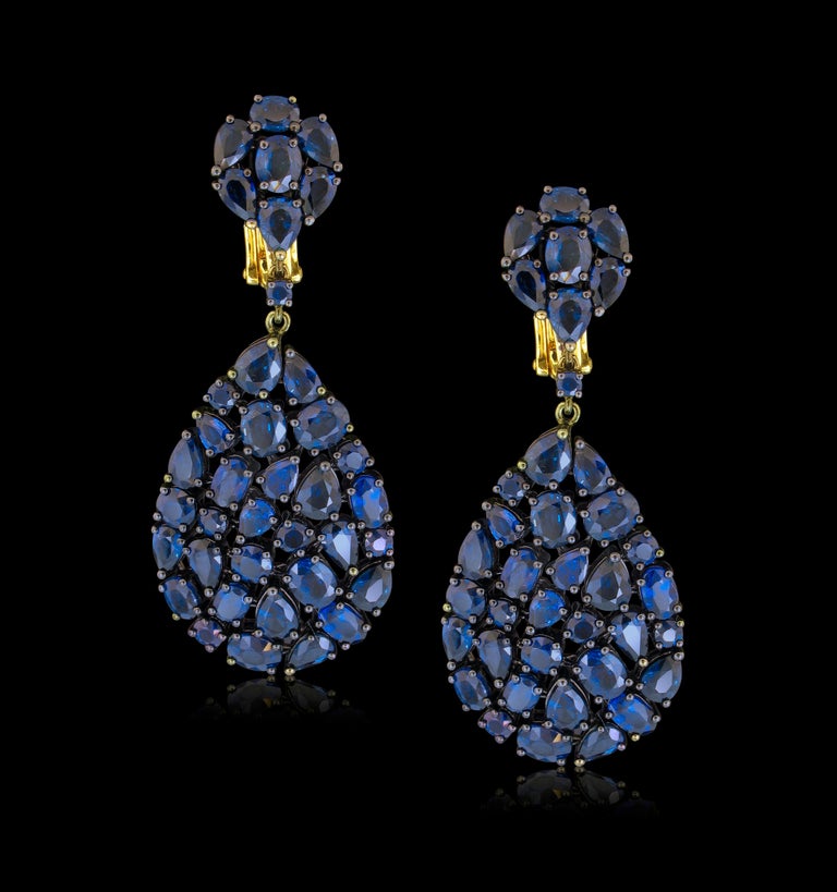 Etho Maria's Brilliant Blue Sapphires appear to float in an almost invisible setting which is entirely flexible.  Fully Faceted Oval and Pear Shaped Sapphires weigh a total of 20.10 carats.  18k Black Rhodium plated gold.  Collapsible post backs