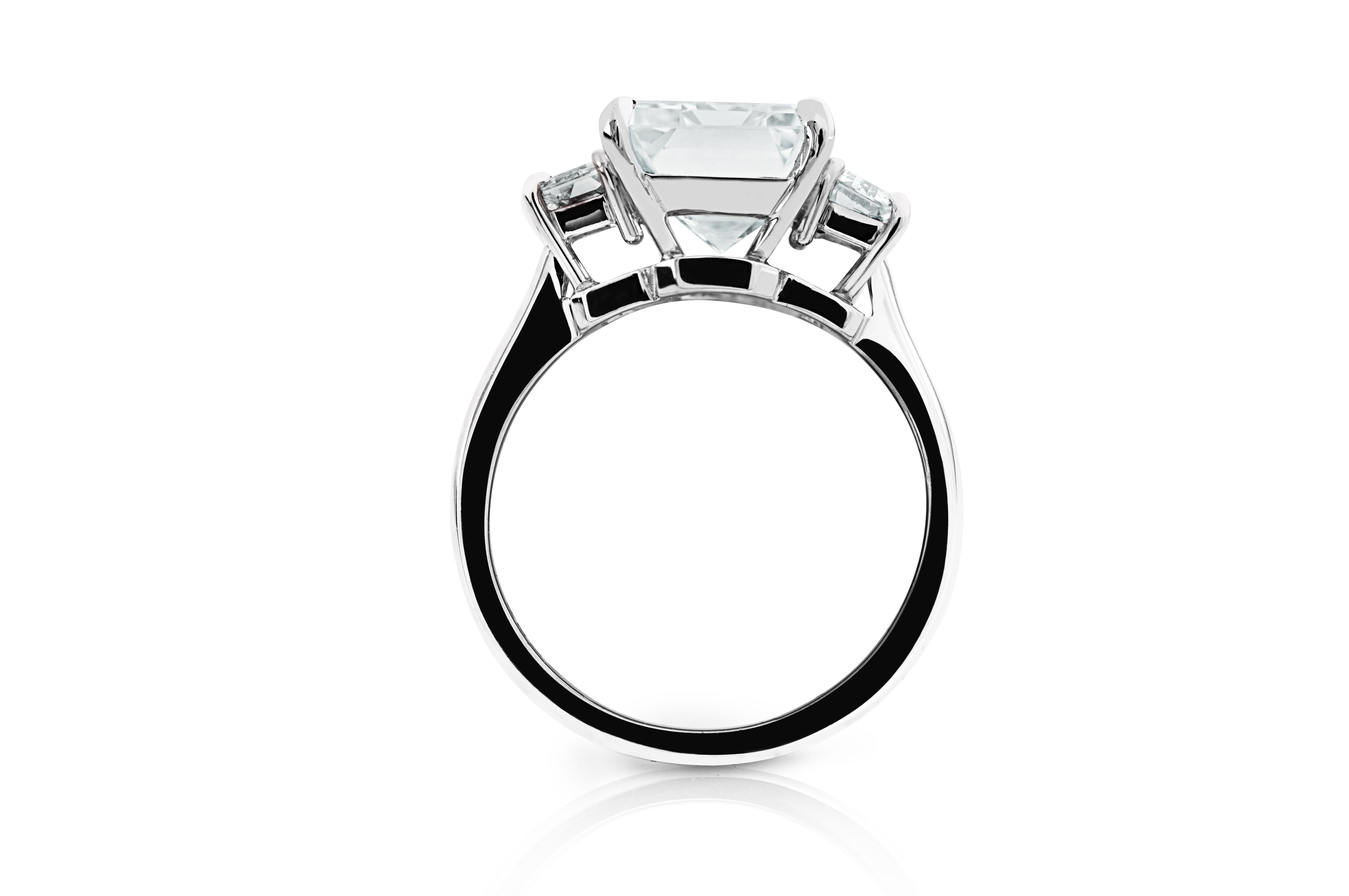 GIA Certified 5.80 carat Emerald-Cut diamond is perfectly accentuated with another two beautifully emerald cut diamonds mounted on the side respectively in Platinum ring. This stylish three-stone ring features the sophisticated statement and the
