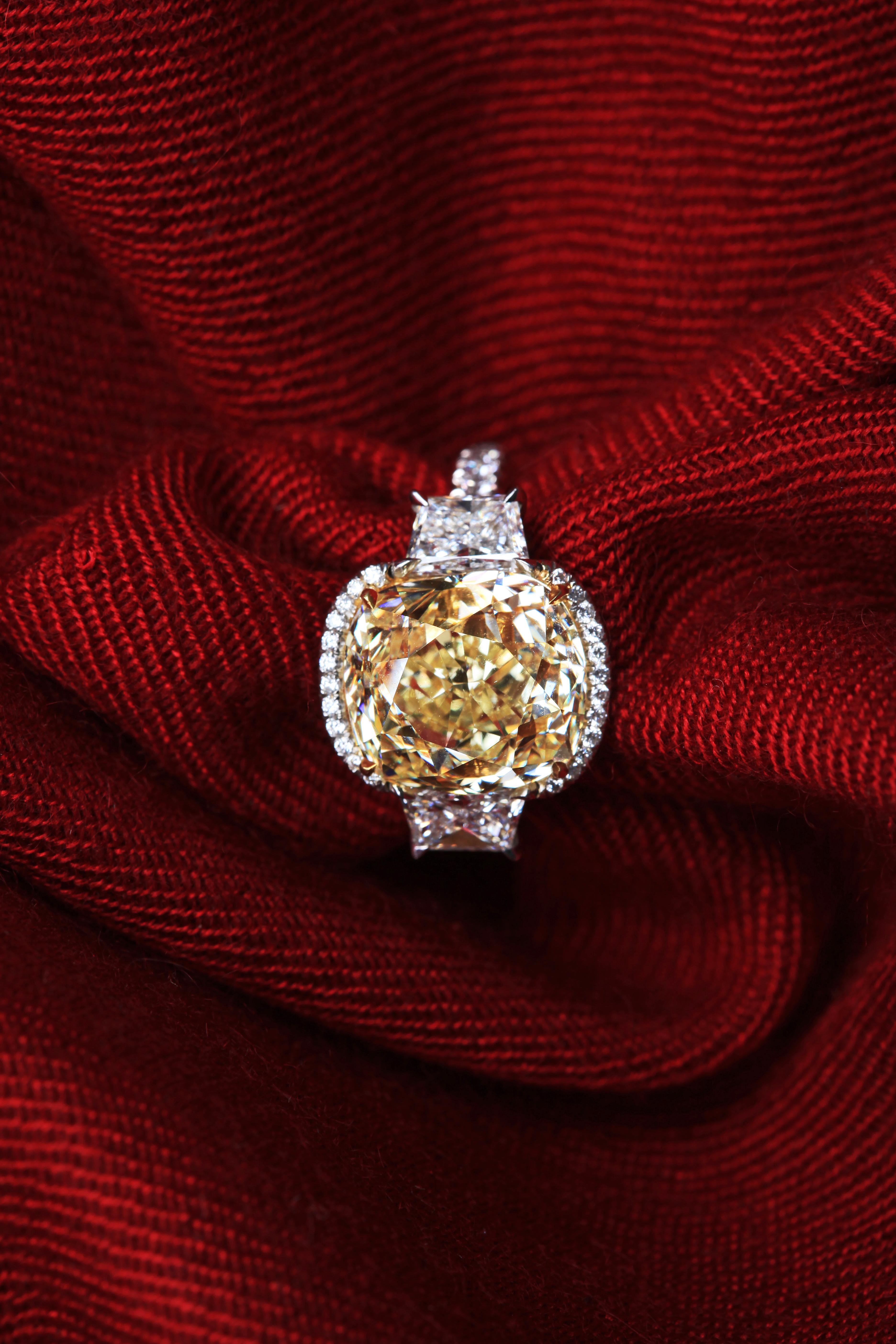 The beautiful GIA certified 9.77 carat fancy yellow old cut cushion diamond from a rare collection, is framed by the brilliant round diamonds in Platinum ring. This ring gives you a big impression of joyfulness and sparkling wherever you go. Yellow