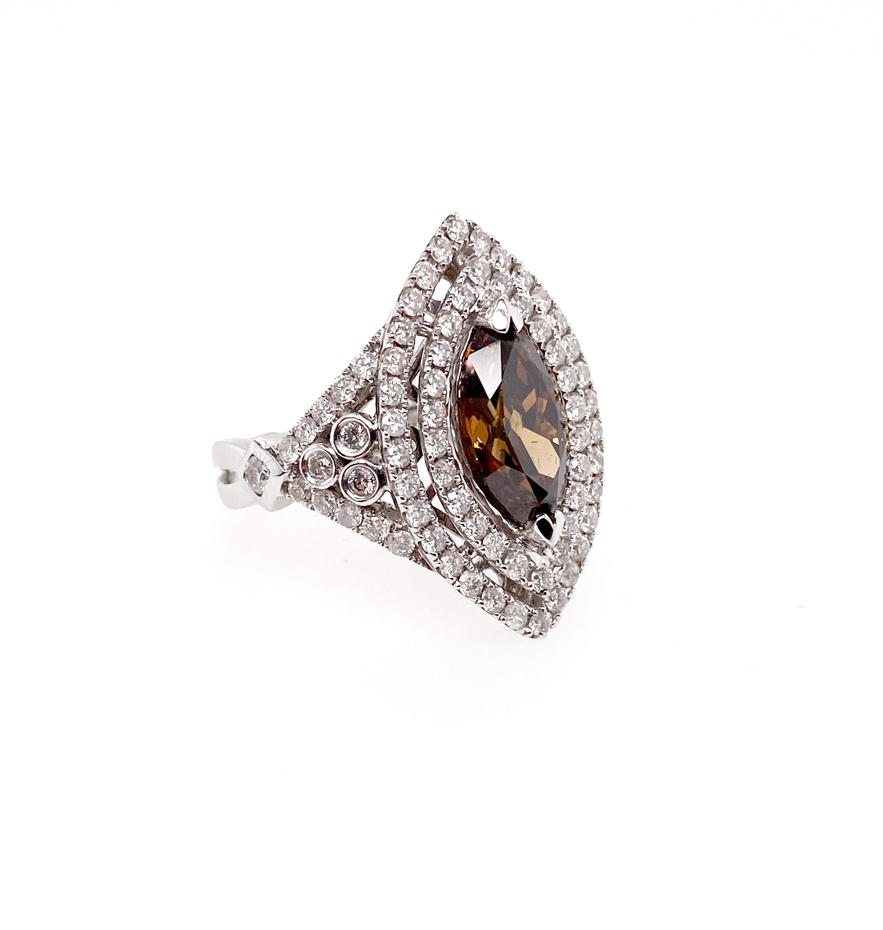 GIA certified 2.44 carat Fancy Brown Oval diamond is mounted as a center diamond of the ring. This rare diamond features unique and gorgeous and is surrounded by brilliant round as a double halo marquise shape design. This ring is so stunning and