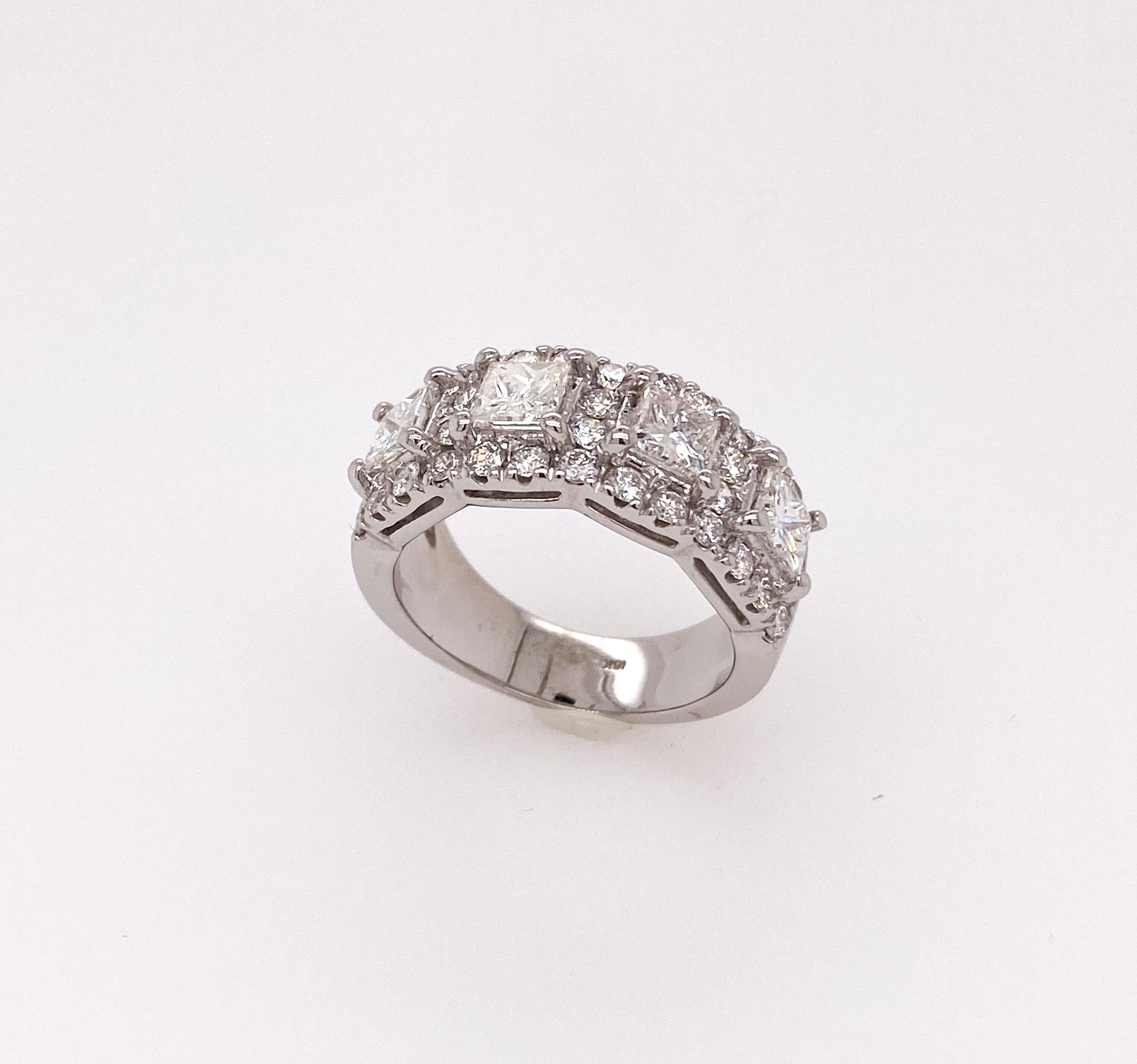 Very classic band with four princess cut diamonds mounted in 18K White Gold and surrounded by additional thirty-six brilliant round cut side diamonds. The band is full of sparkle and can't stop blinking. Perfect for everyday wear or special occasion