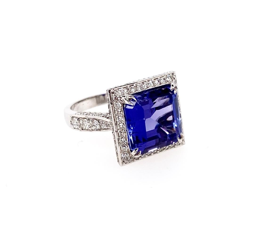 The fine quality 7.52 carat Tanzanite emerald-cut gemstone is set as a center stone of the ring and surrounded by the brilliant round diamonds like the square halo design. The shoulder of the ring also covered with the diamonds. It features the