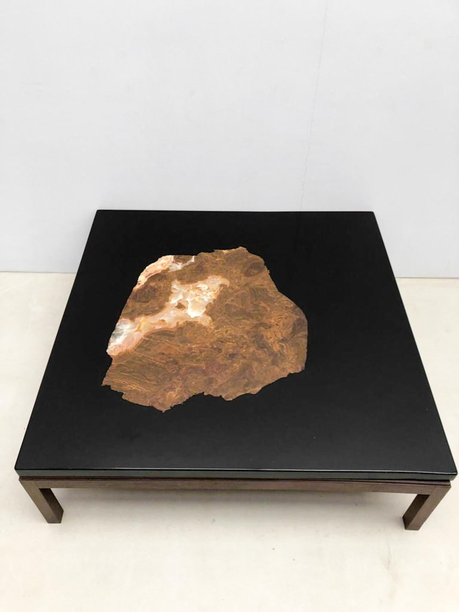 Artisan Etienne Allemeersch, who refined his craft in the workshop of the Belgian artist Ado Chale, crafted this coffee table in resin adorned with inlaid fossil stone. 

Do not hesitate to contact us for any additional information.
We would be more