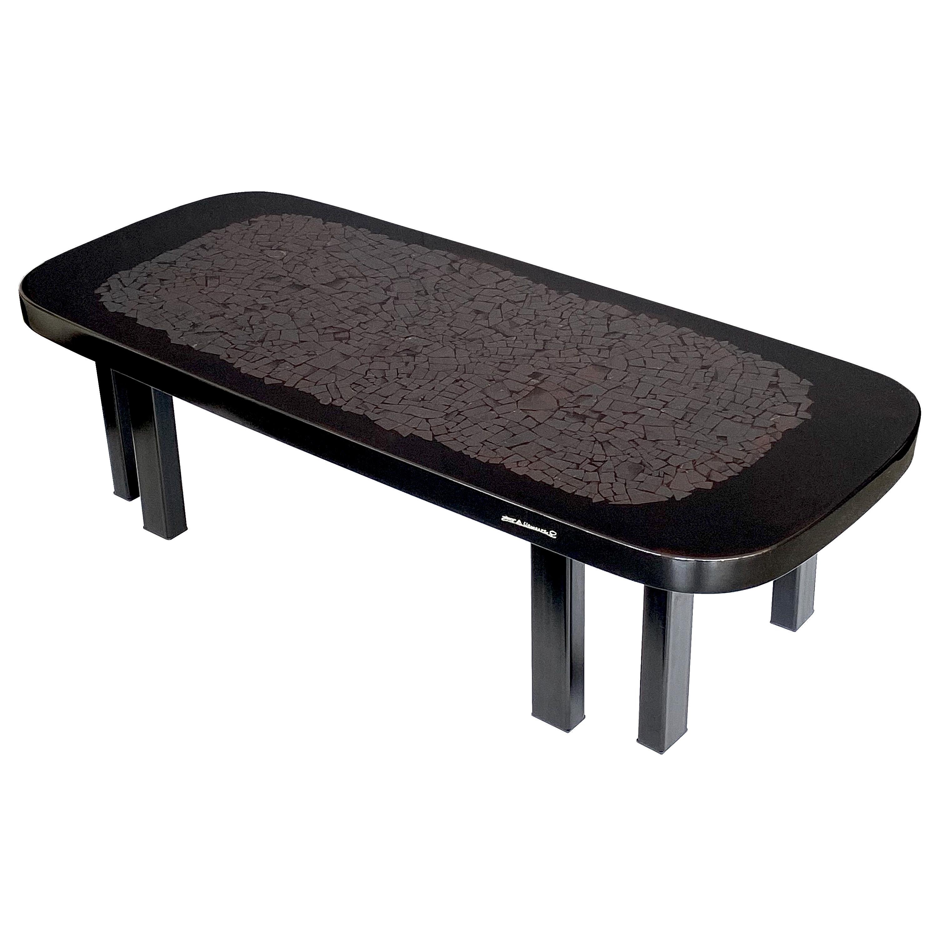 A rectangular coffee table with rounded corners by Etienne Allemeersch, circa 1970s, Belgium. This cocktail table is inlaid with a mosaic of sliced hematite stones. The stones are inlaid in black resin and the table top is highly polished. The