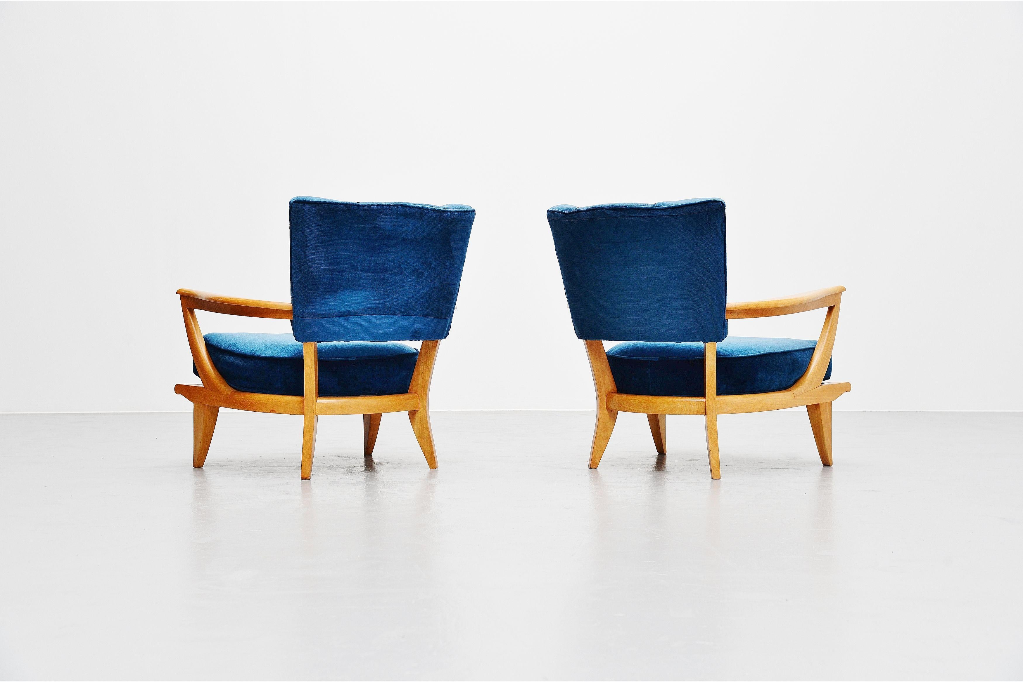Stunning pair of low lounge chairs model SK40 designed by Etienne-Henri Martin and manufactured by Steiner, France 1952. These chairs have a solid beech frame which is fully refinished and in excellent condition. They also still have their original