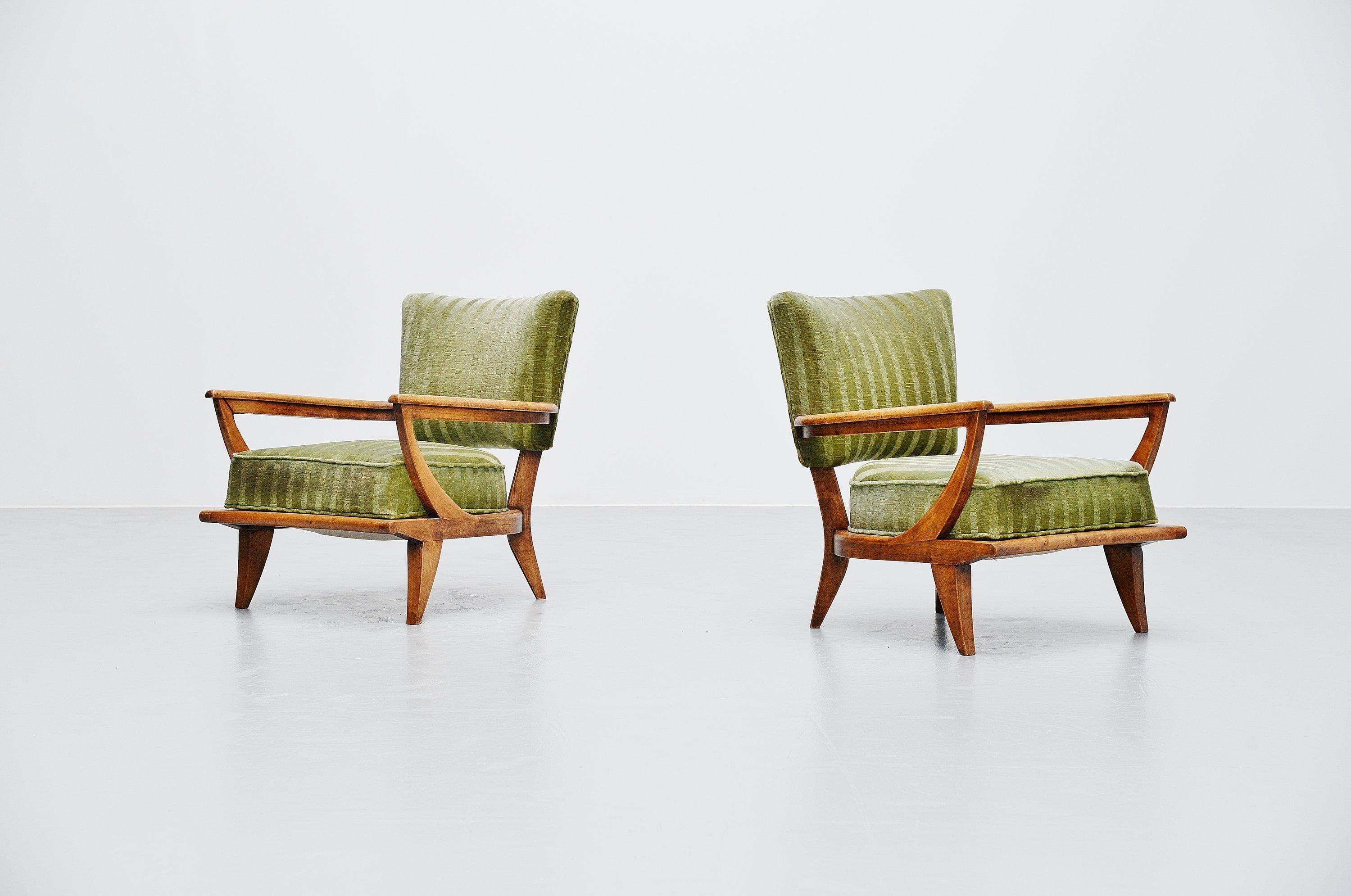 Fabulous pair of lounge chairs model SK40 designed by Etienne-Henri Martin and manufactured by Steiner, France, 1952. These chairs have a solid beech frame with amazing patina from age. They also still have their original striped mohair upholstery