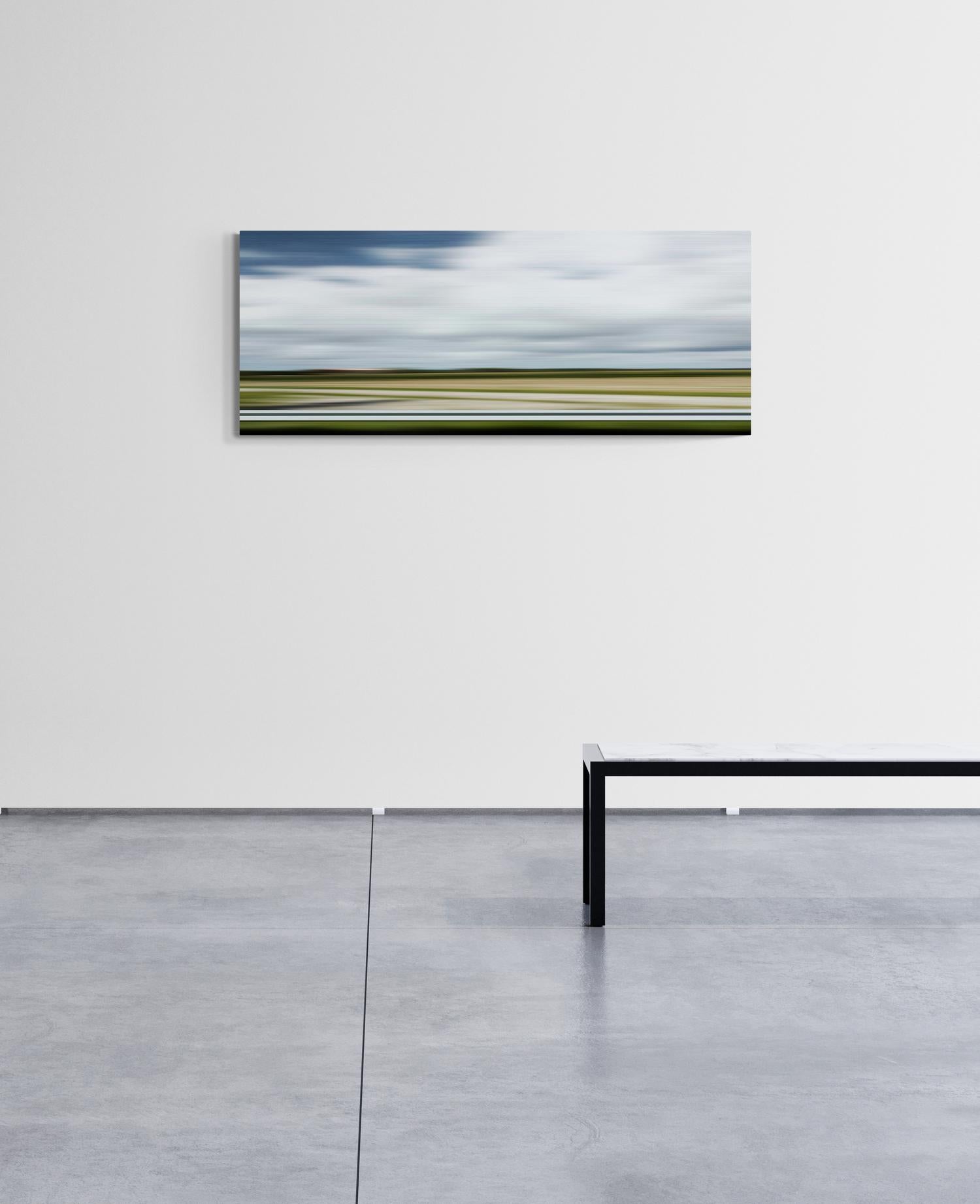 Bright clouds hover over a landscape striped in green, ochre and sienna in this unique depiction of a township in France, Auterive.

Labbe uses time lapse photography to capture this image of the landscape while he himself is in motion. His large