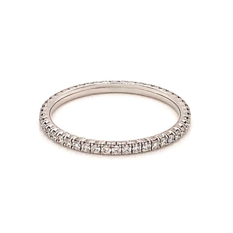 Étincelle de Cartier eternity diamond wedding band, 18K white gold, set with 49 brilliant-cut diamonds totaling 0.22 carats. 1.52 mm wide. This ring is pre-owned in excellent condition, like new. This gorgeous diamond band is just stunning.

Ring