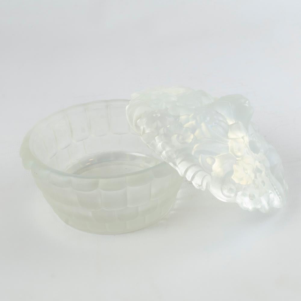 
Etling France Art Deco candy box / powder dish in opalescent glass 1930s

decorated with flowers and foliage in relief. Art glass: 1930s. 
Model number: 217

 Measurements:

7,5 centimeters high
10,5 centimeters diameter

In very good shape. 
Stamp