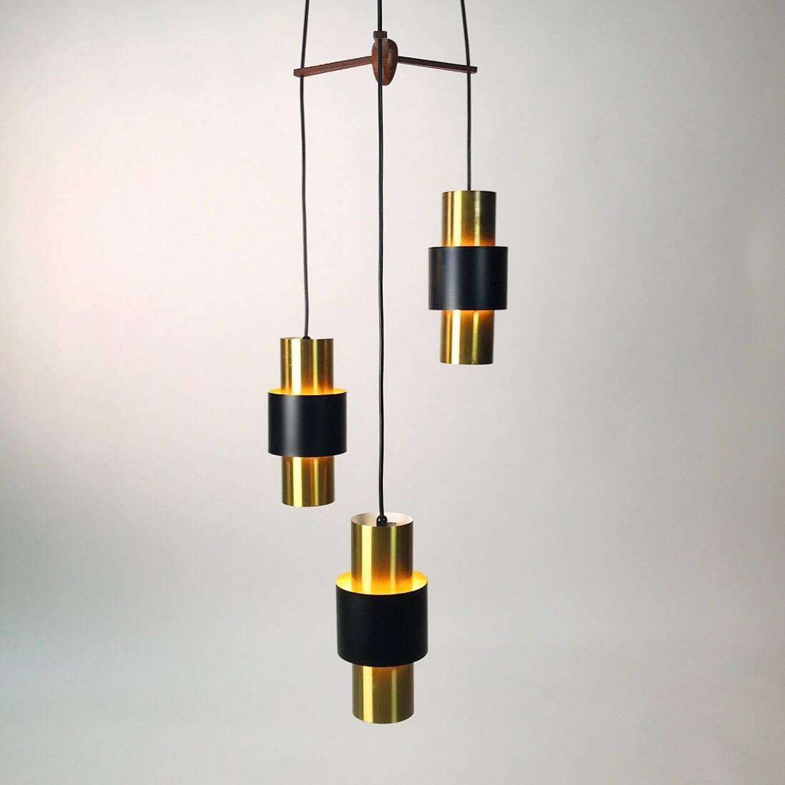 Beautiful classic brass ceiling light Etna by Jo Hammerborg for Fog and Morup, Denmark 1966.

Brass light with a centrepiece of black lacquer and a wooden suspension. 

Good vintage condition with some patina to the surface of one of the lights.