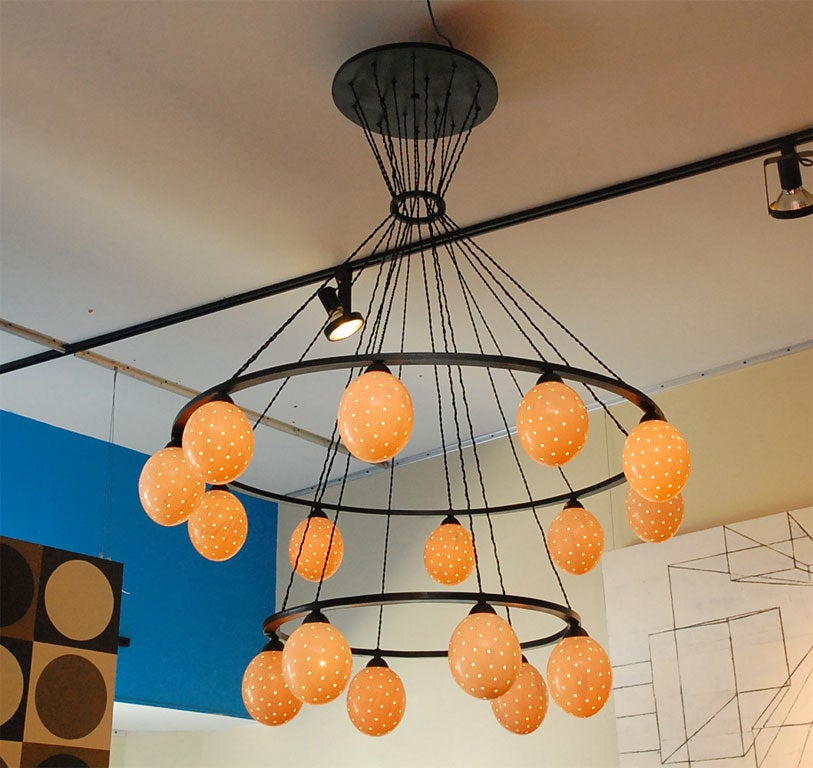 Two rings of ostrich eggs connected by braided silk wire give this chandelier a majestic presence. This chandelier has 16 lights with the real ostrich egg diffusers. The light is made custom and can be made to meet your size requirements. Light has