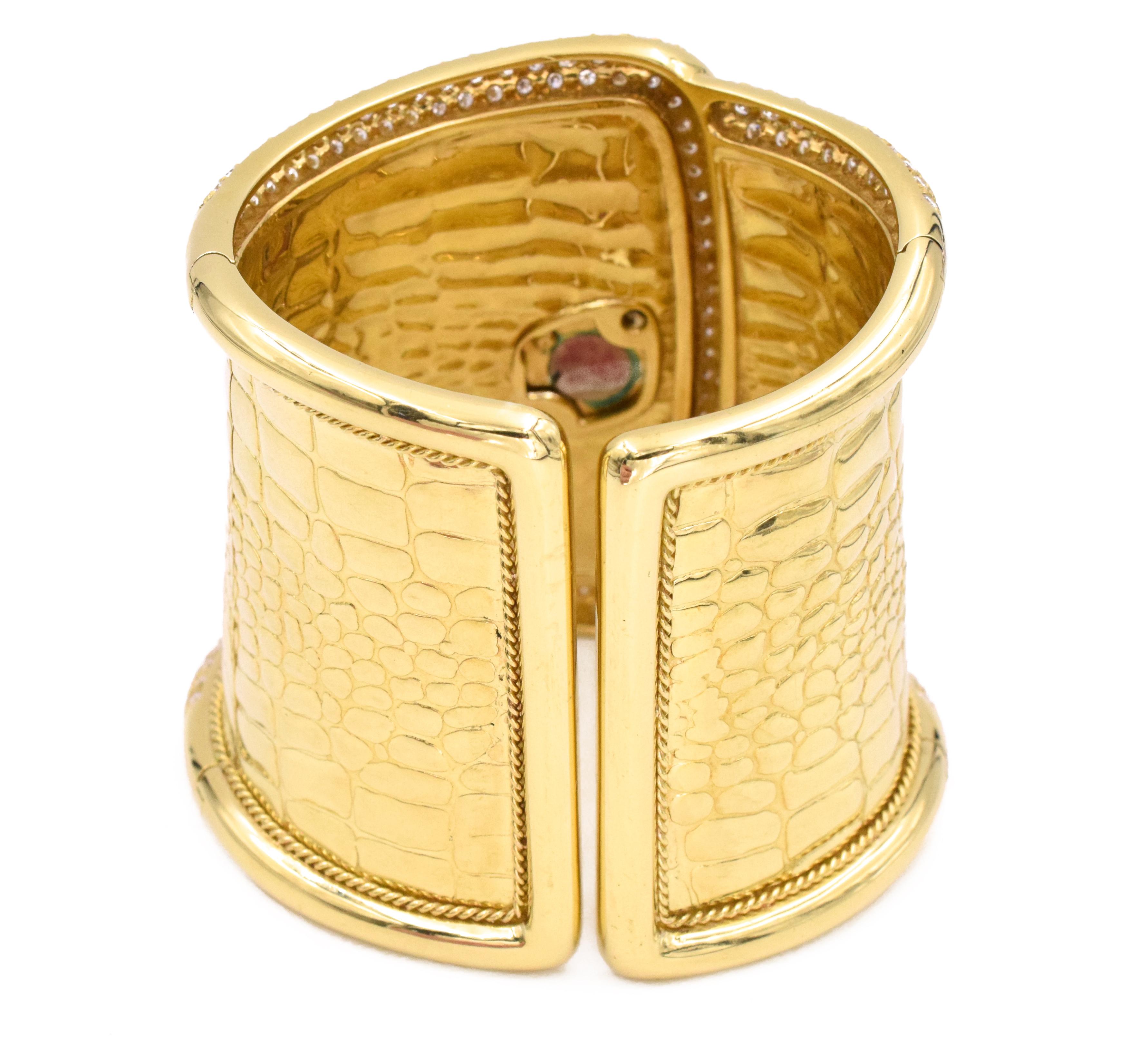 Etoile diamond cuff watch made in 18k yellow gold. The front half of the cuff around the edges, face of the watch, halo and leaf designs around the watch are pave set with round brilliant cut diamonds. Accented with larger marquise and pear shape