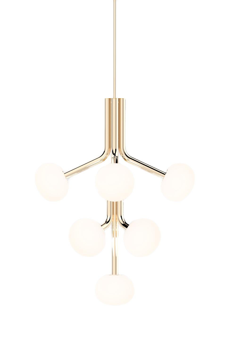 The graceful Etoile collection is composed of curved limbs providing a soft glow from the sand blasted, hand blown glass shades. The drop and stems are finished in either polished brass or nickel, or matte black.