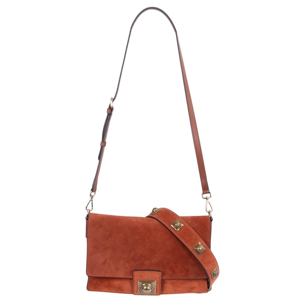 100% authentic Etro Crown Me shoulder bag in rust brown suede leather embellished strap and closure made of antique gold-tone hardware. Interior is lined in rust brown calfskin and suede divided in two copartments with one zipper pocket against the