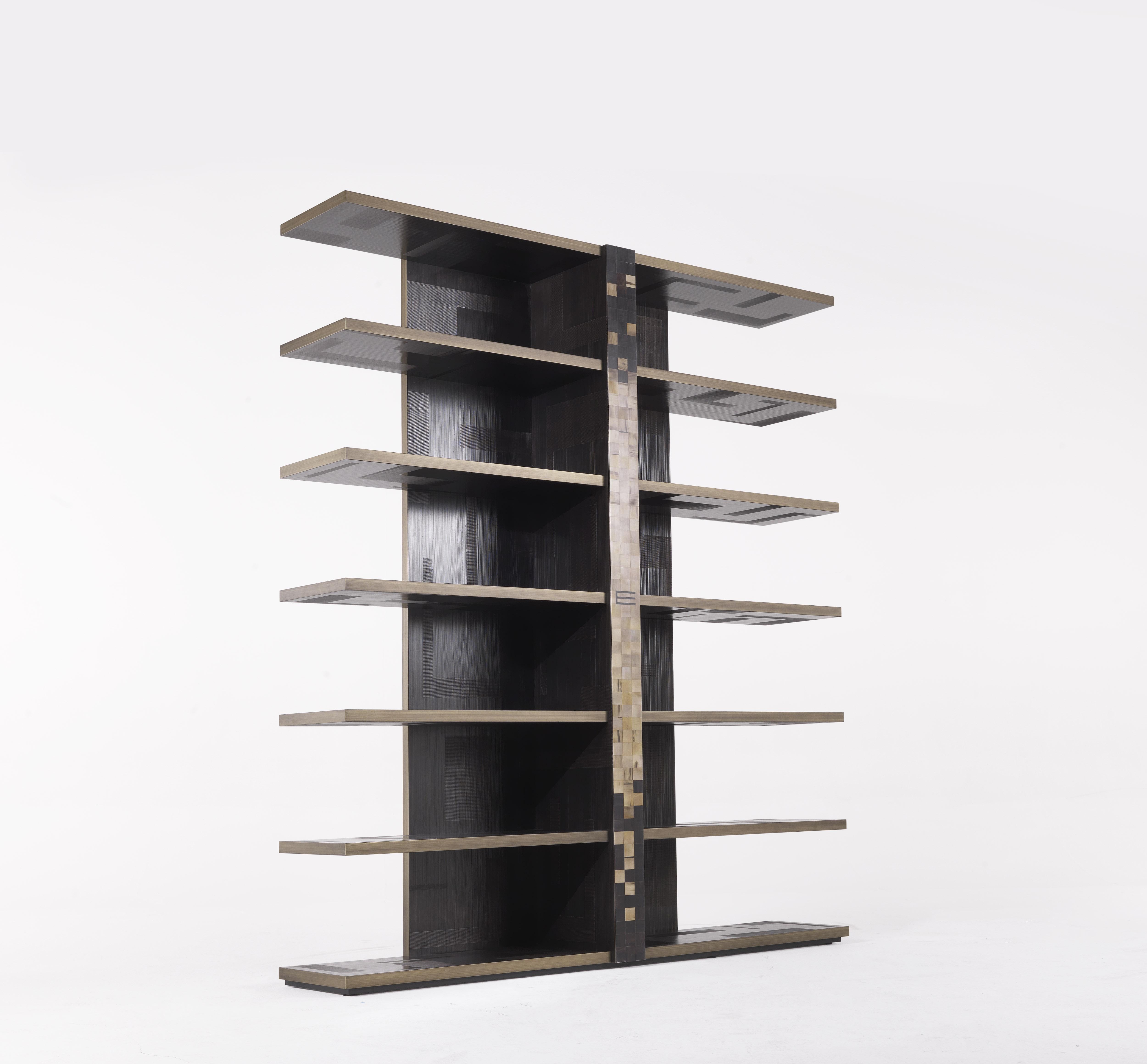 Contemporary design and decorative spirit for the Aleppo bookcase, characterized, in the central spine, by a horn inlay recreating a mosaic pattern, reference to the decorative theme of the Mesopotamian world and to the ethnic spirit that