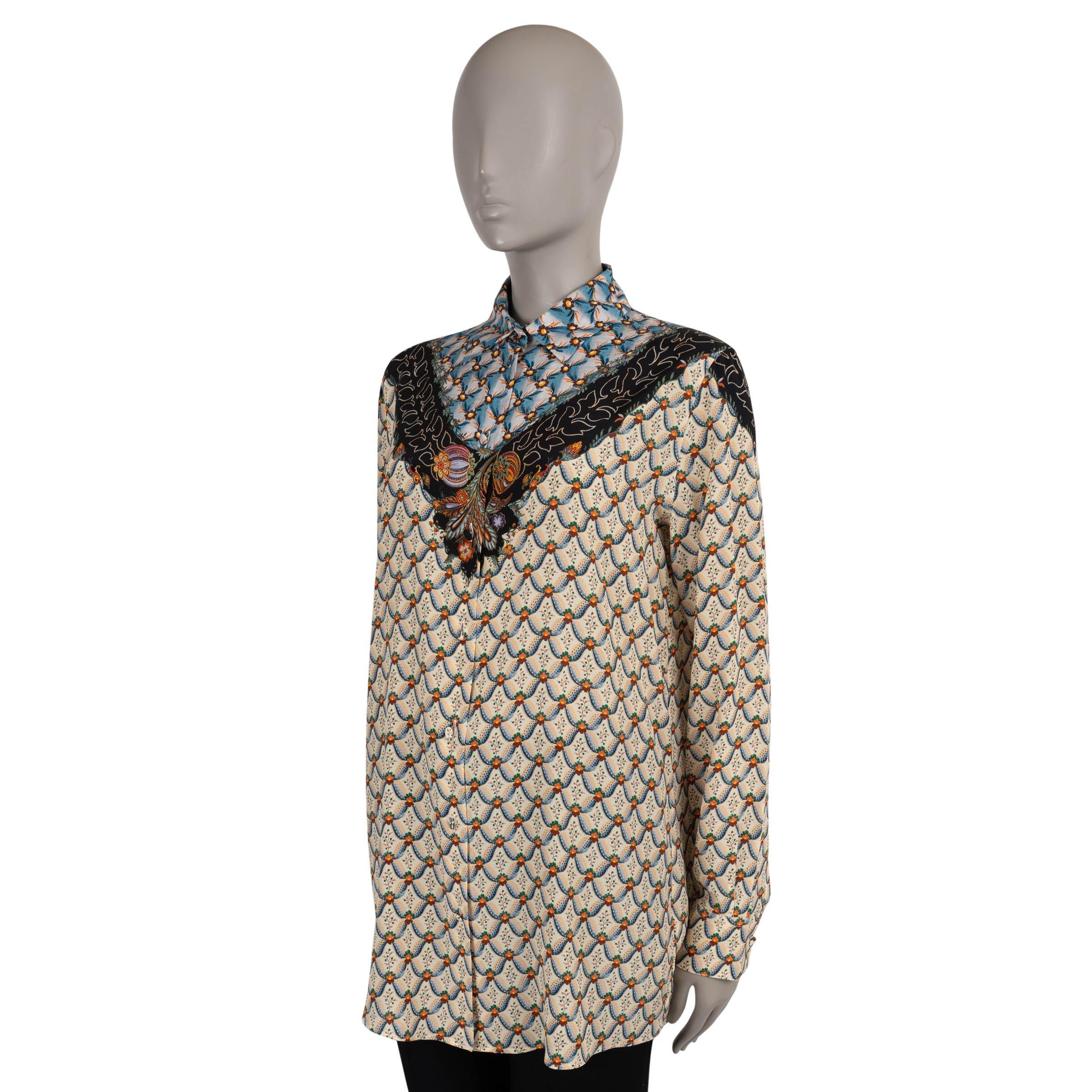 This 100% authentic Etro blouse is crafted in beige, blue, and orange Floralia crepe de chine silk (100%). It features a relaxed silhouette with a classic collar, long sleeves, and buttoned cuffs. The front opens with concealed buttons for a