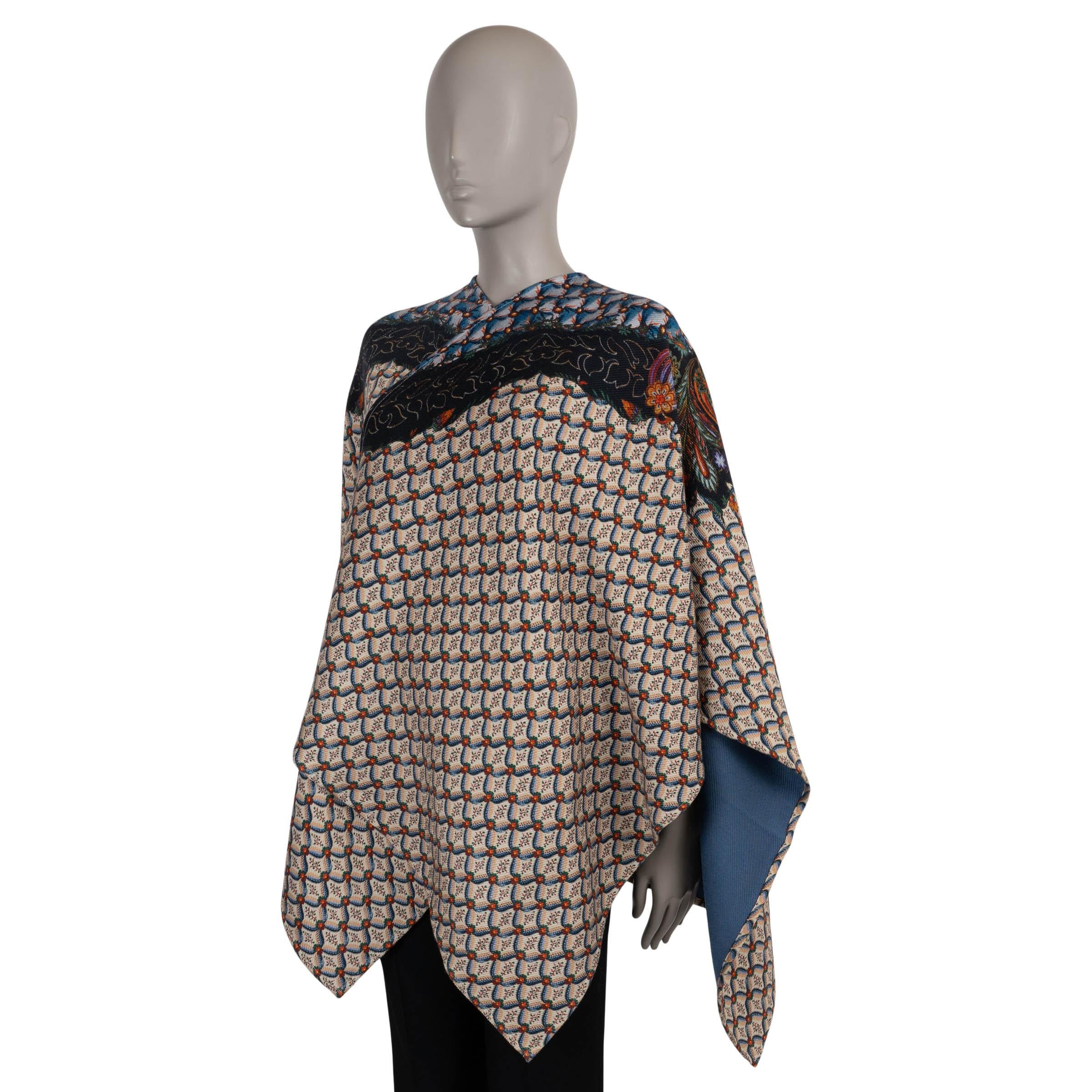 This 100% authentic Etro cape is crafted in beige, blue, and orange Floralia twill wool (85%) and viscose (15%)—please note the content tag is missing. Designed with a relaxed silhouette, it features a handkerchief hem, v-neckline, and 3/4 length