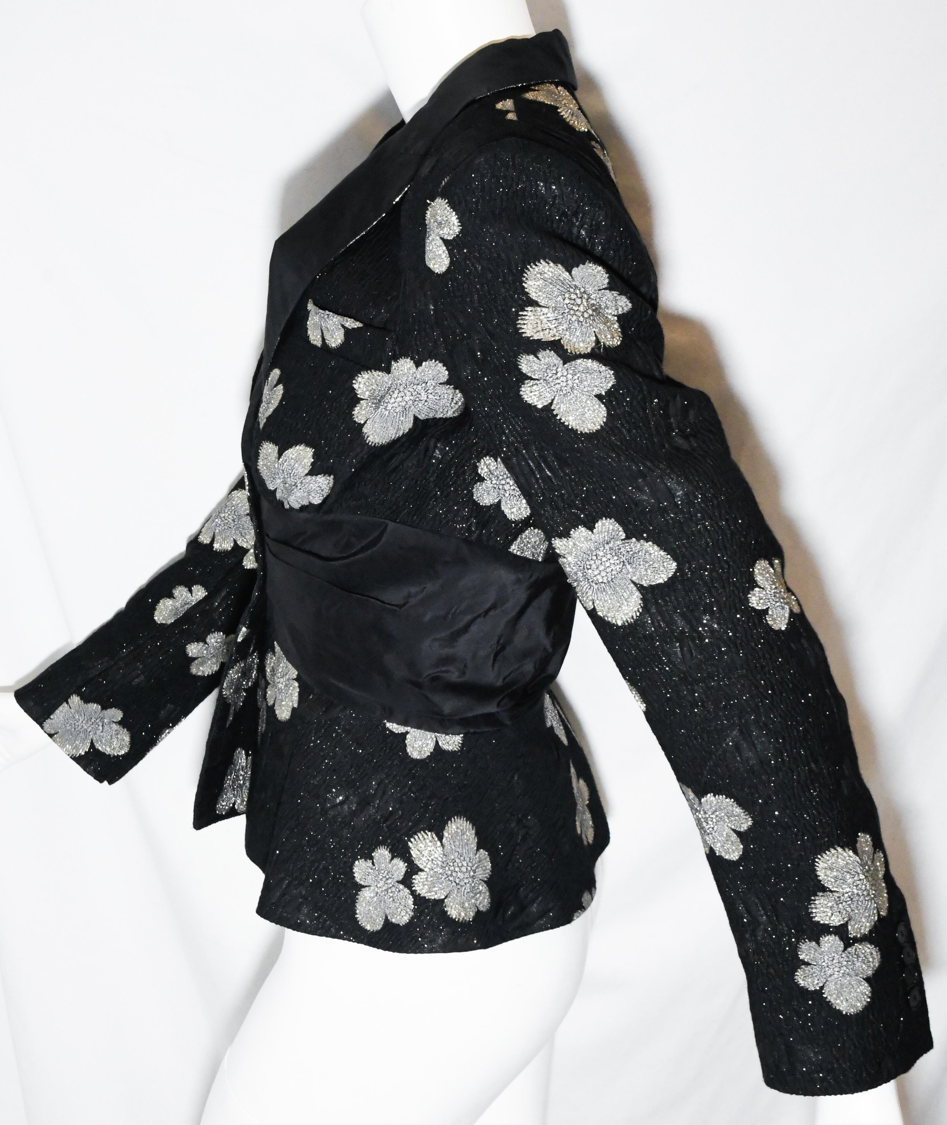 Etro black jacket decorated with silver thread flowers throughout.  This shawl lapel jacket does not contain the silver thread flowers and includes a pleated cinched waist.  Jacket is lined in black silk.  Two buttons at waist for closure.  Jacket