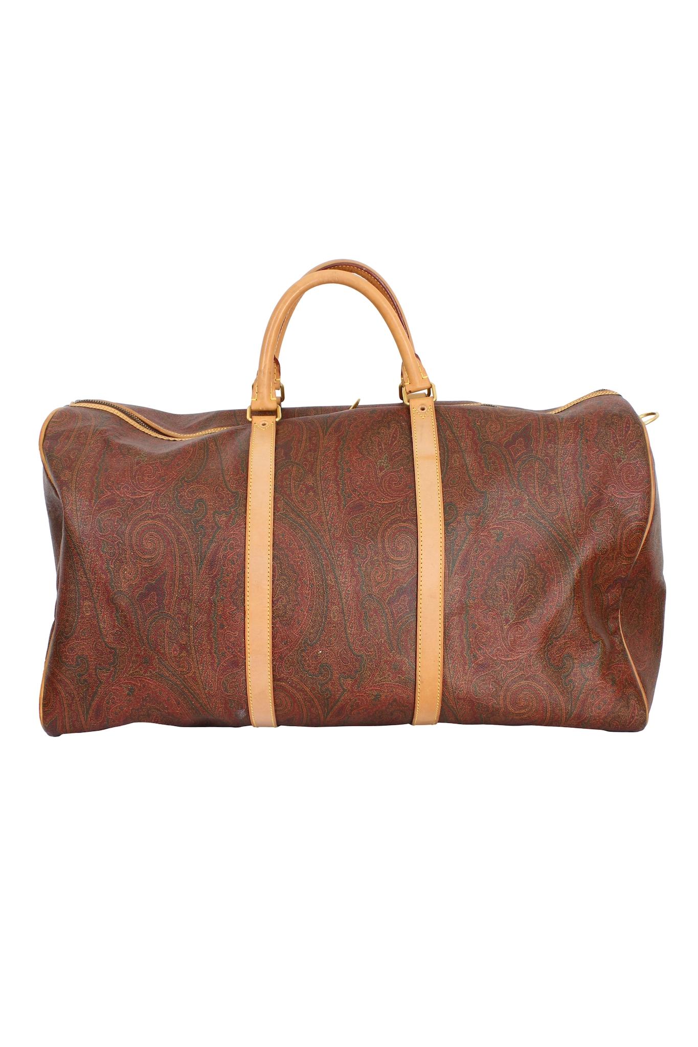 Etro Boston model duffle bag, vintage 1995s. Brown and beige color with paisley print. Top zip closure, two round handles, single compartment, internal zip pocket. Canvas and leather fabric. Made in Italy.

Code: 0720912 - 27 Oct 95 - 0005

Height: