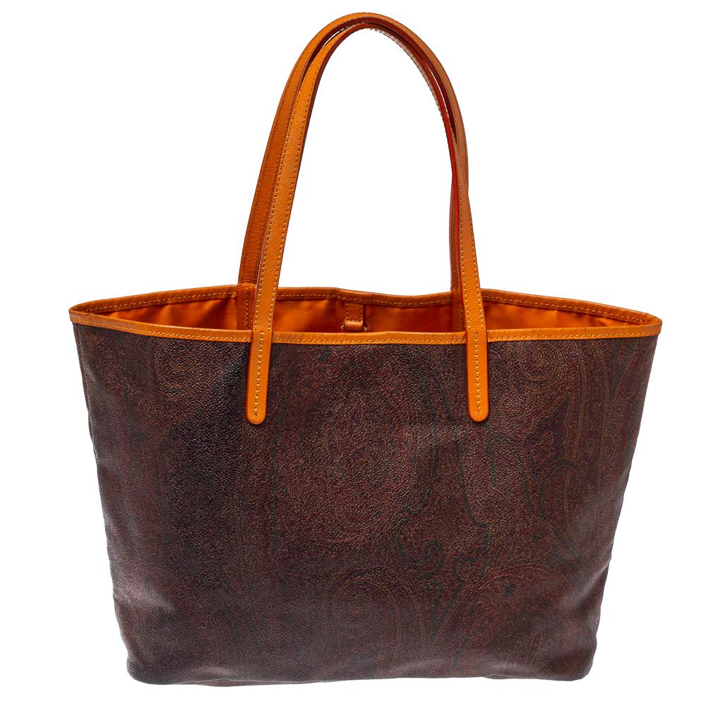 Etro is famous for its intricate prints, exceptional quality, and designs. This brown paisley printed tote is crafted from coated canvas & orange leather and comes with a nylon-lined interior that will hold all your daily necessities. The bag is