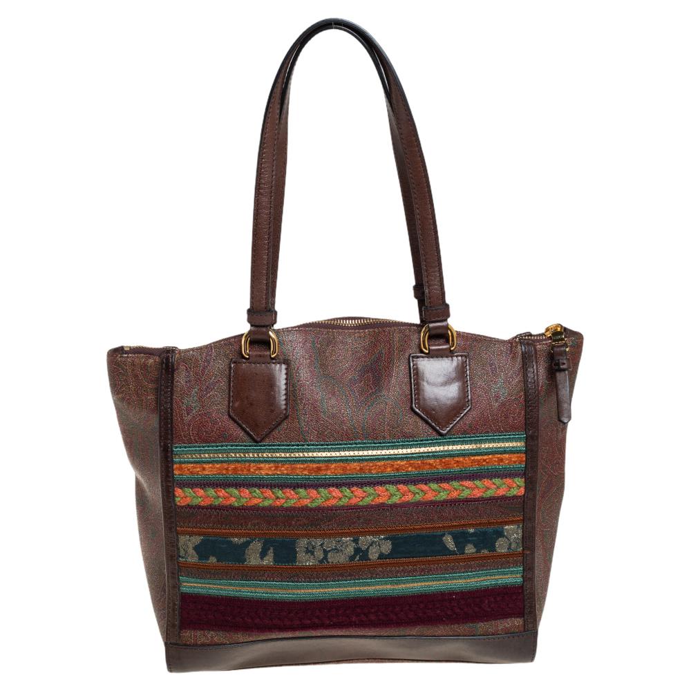 Featuring the ornate style of Etro, this tote is perfect for storing all that you need for the day and hence, is a must-have everyday essential. The paisley-printed canvas and leather exterior is accented with multicolored patchwork. It comes with