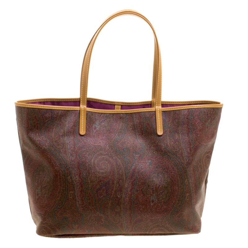 This shoppers tote from the house of Etro is perfect for travelling, beach outings or picnics. It features a brown paisley printed coated canvas body and secured with a hook closure. It comes with a bright printed interior fitted with a zipper wall