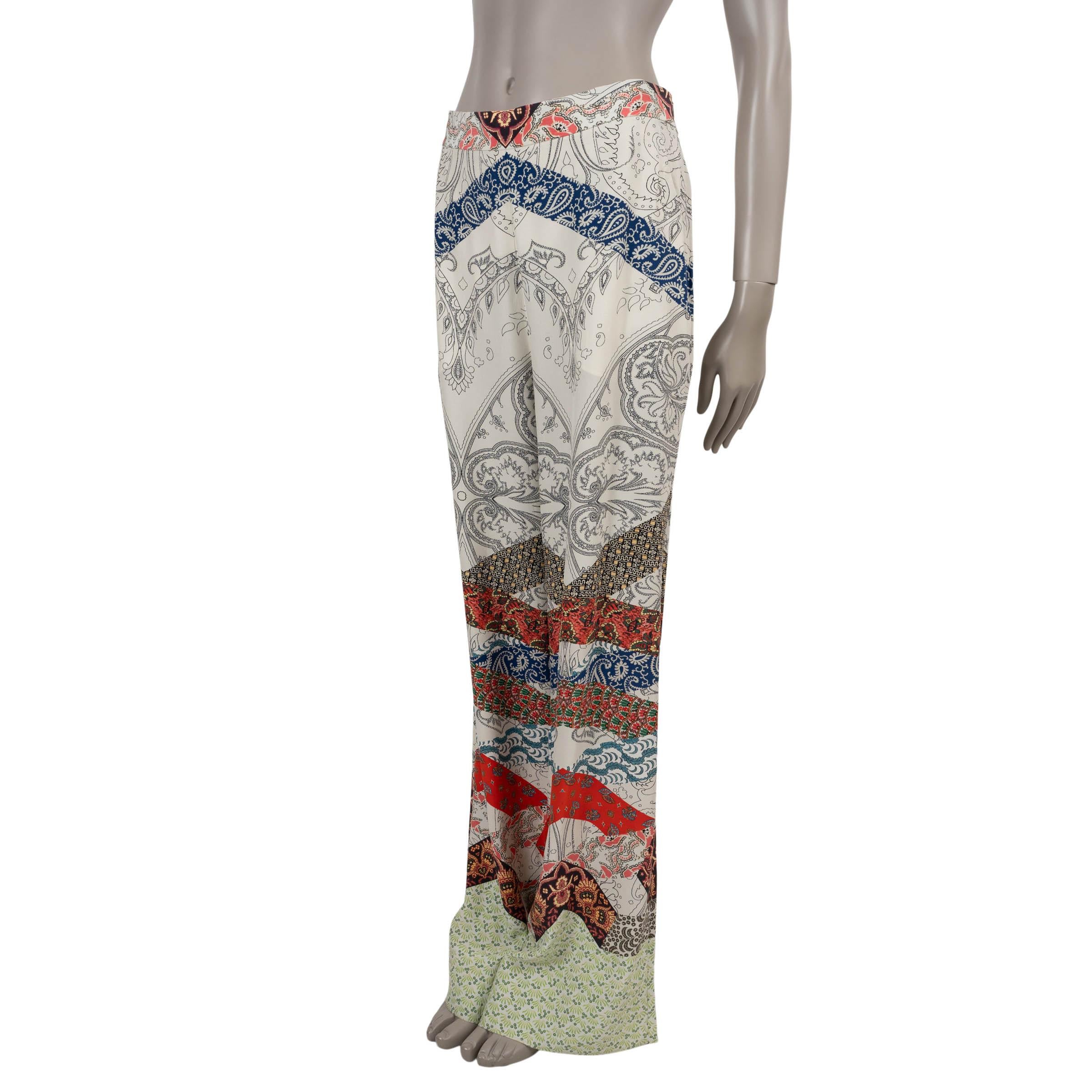These 100% authentic Etro pants are crafted in cream crepe silk (100%) and adorned with a mixed paisley print in shades of blue, red, green, and grey. Designed with a high-waisted silhouette and flowing wide legs, they feature an elastic waistband