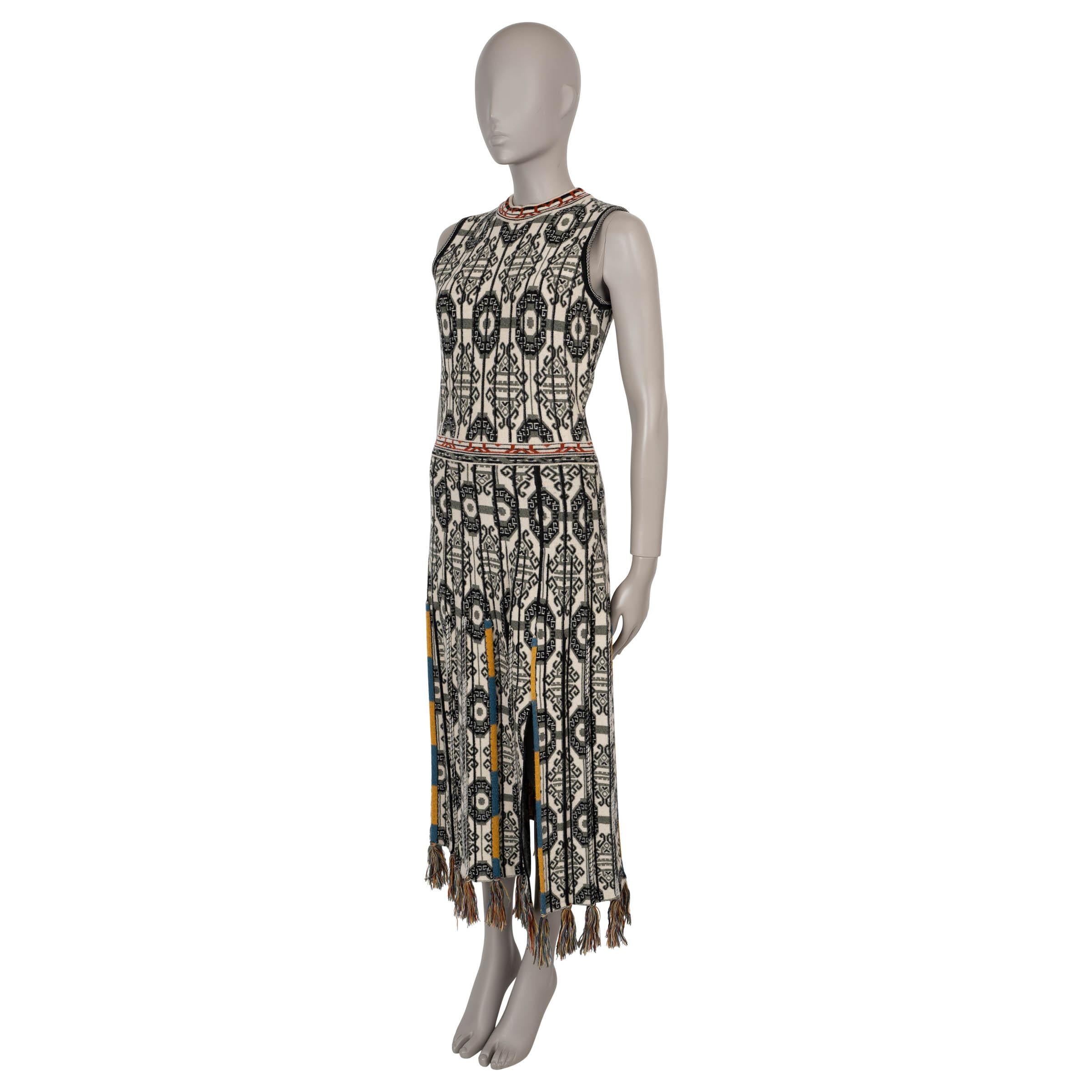 This 100% authentic Etro knit dress showcases a striking cream, black, and brown geometric jacquard pattern in wool (with 3% cotton), enhanced by blue and yellow embroidery for an artisanal touch. It features a fitted silhouette with a midi length,