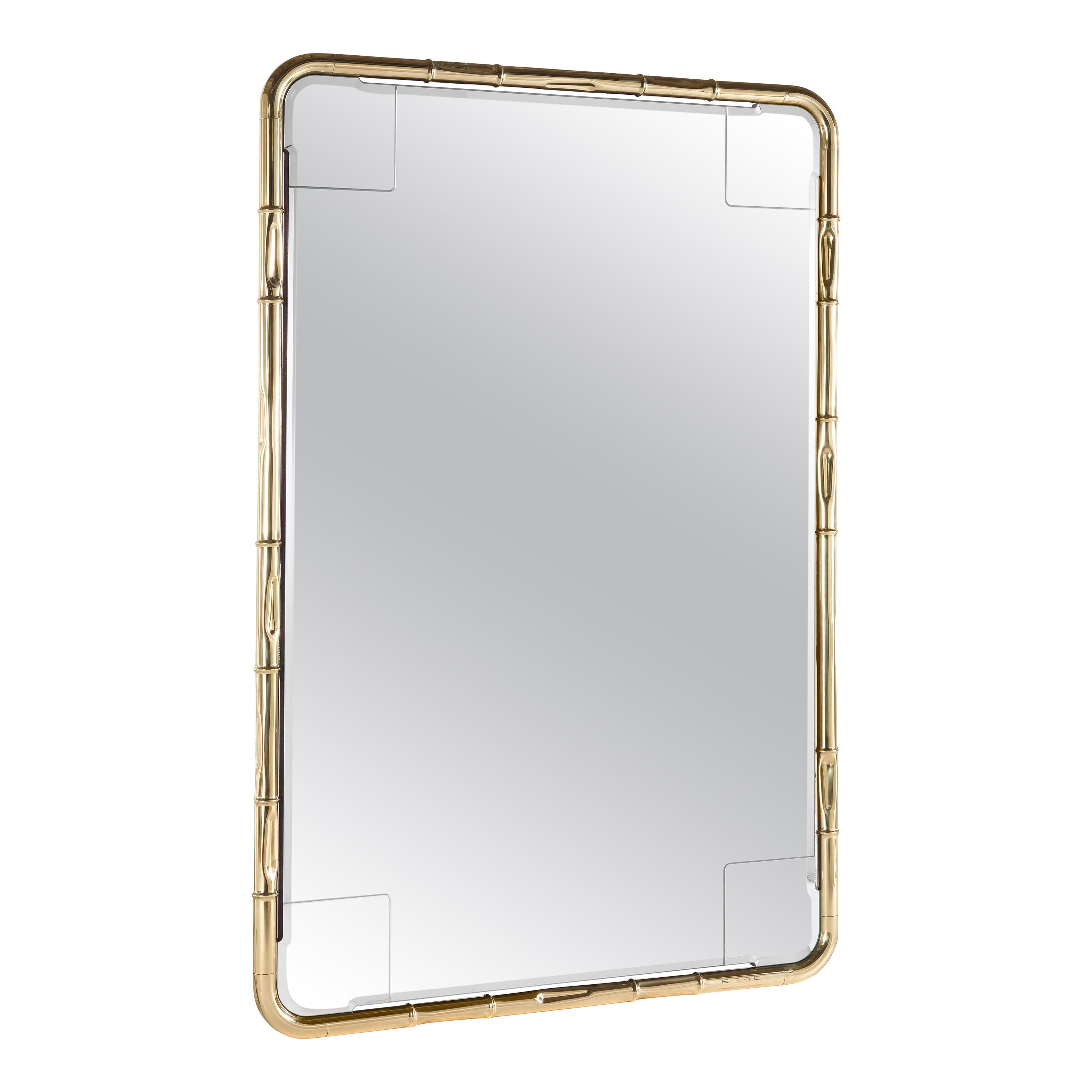 An elegant, nature-inspired mirror with bamboo canes 
recalling a typical Asian environment, reinterpreted with a bright and chic touch, expressed in the precious details such ad the polished brass finishing. A fascinating element that can be placed