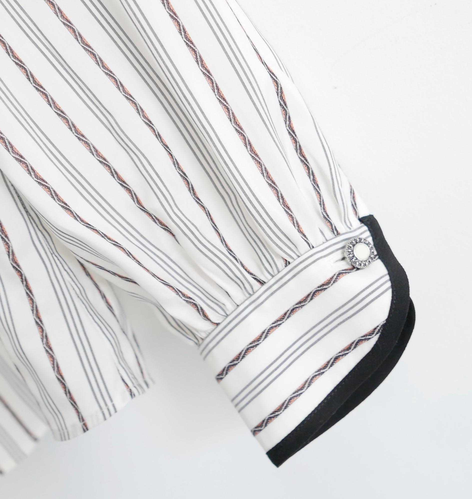 Beautifully detailed Etro striped silk blouse. Bought for £875 and new with tag/spare buttons. Made from gently textured white and grey grandad striped silk with delicate embroidered striped embellishments. It has black piped edgings, decorative