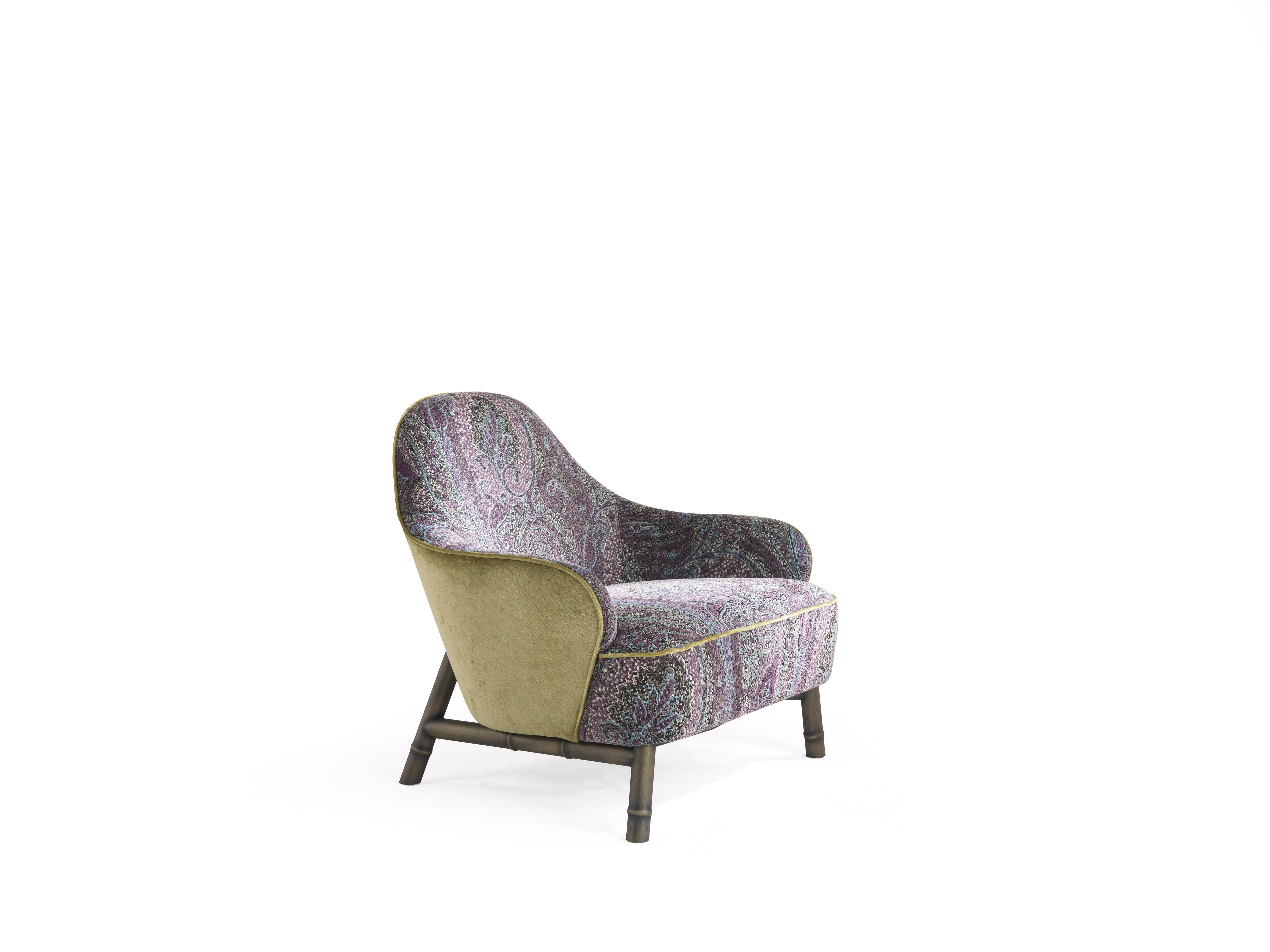 The rich and evocative fabric of the new Home Interiors Collection is the main feature of the Frida armchair, whose precious and inimitable style is enhanced by the velvet piping, by the bronzed finish legs with bamboo shape and by precious monkey
