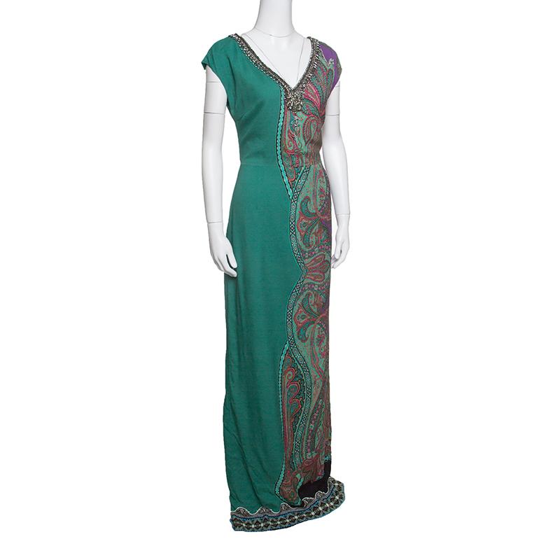 Etro's maxi dress strikes a stunning balance between contemporary style and dreamy silhouette. The signature paisley print adorning the half side of this dress and striking embellishments accented on the V-neckline create an aura of elegance and