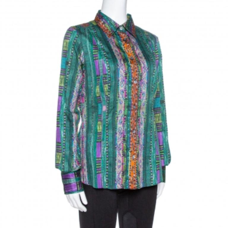 This green shirt from Etro caters to boho-luxe designs for the modern woman. It is made of a cotton blend and features an abstract print all over. It has sharp collars, front button fastenings, and long sleeves. Pair it with smart pants and ballet