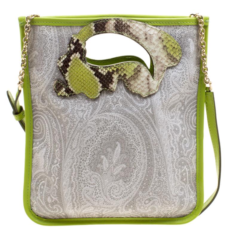 This unique crossbody bag from the house of Etro features a coated canvas body detailed with grey and green paisley print on it. Attached with a slim strap, this bag comes with a paisley shaped cut-out to use it as a hand-held style. Finished with