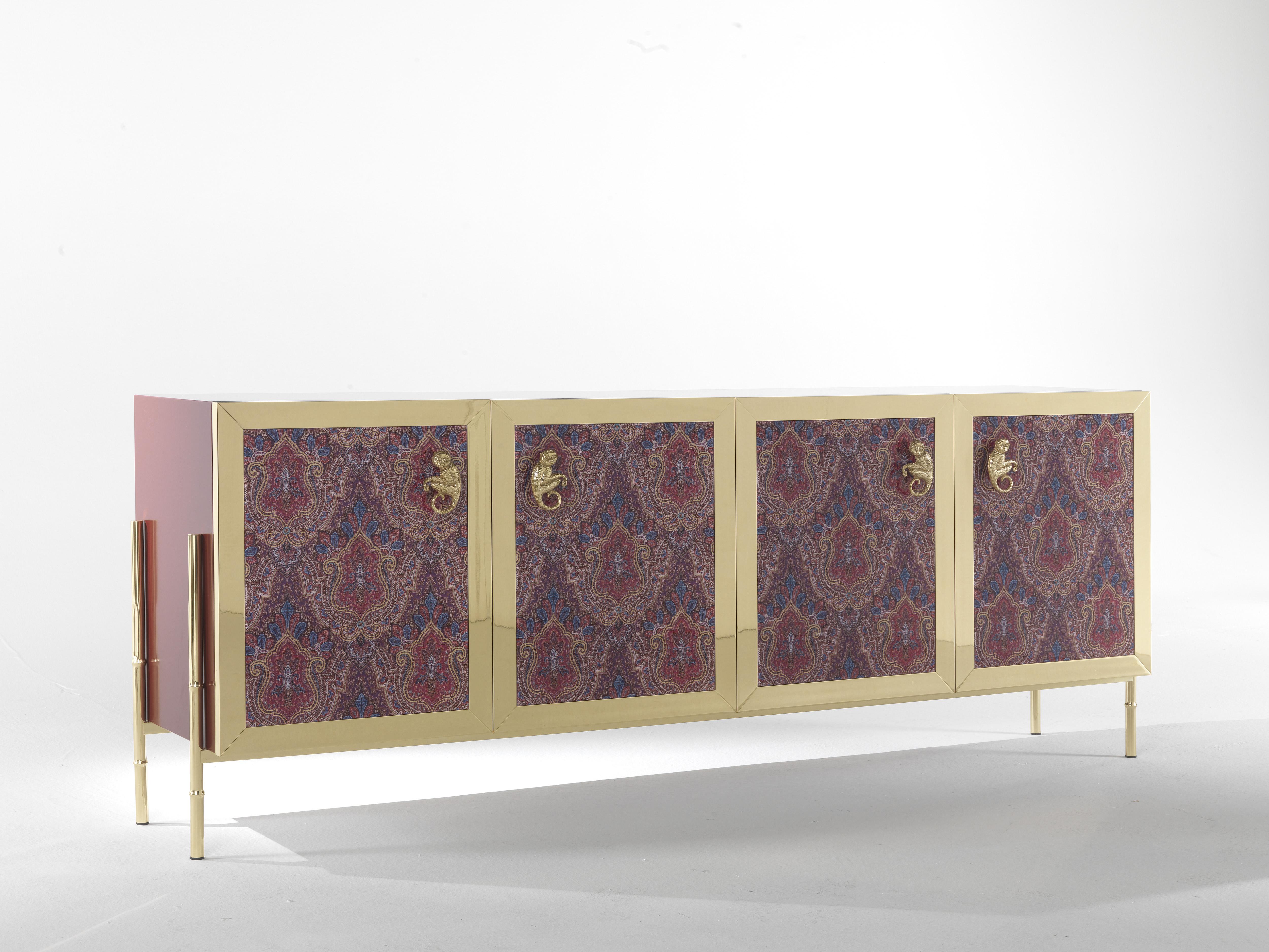 Nomadic spirit and air of travel in a piece of furniture in perfect Etro Home Interior style. The rich Deosai pattern and the monkey applied to the doors, the bamboo canes legs and the luminous structure in patinated bronze create a combination of