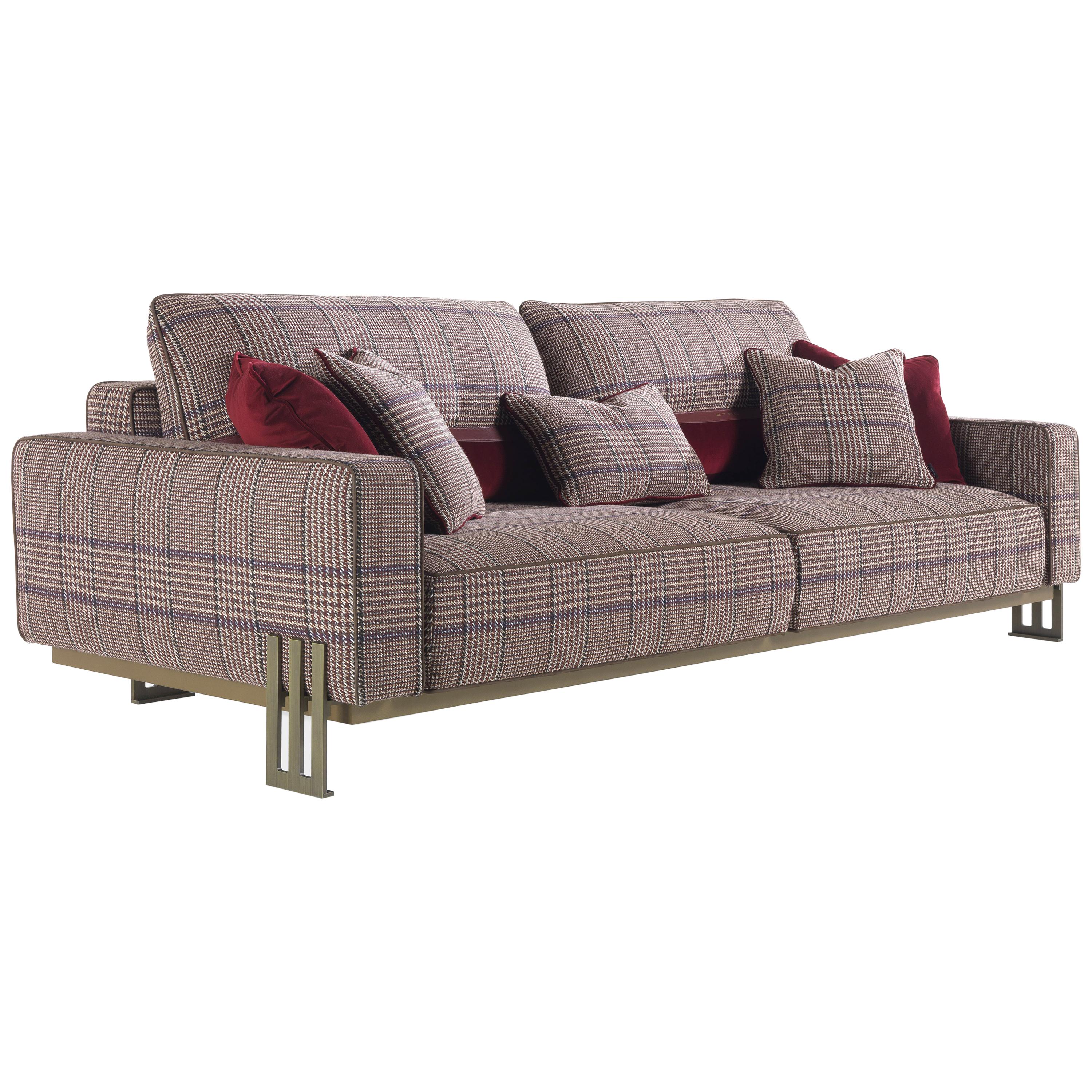 Classic charm and rigorous lines for an elegant sofa able to fit into any environment. The linear shape of the frame in patinated bronze metal meets the elegance of the upholstery in fabric from the Etro Home Interiors collection, creating a mix