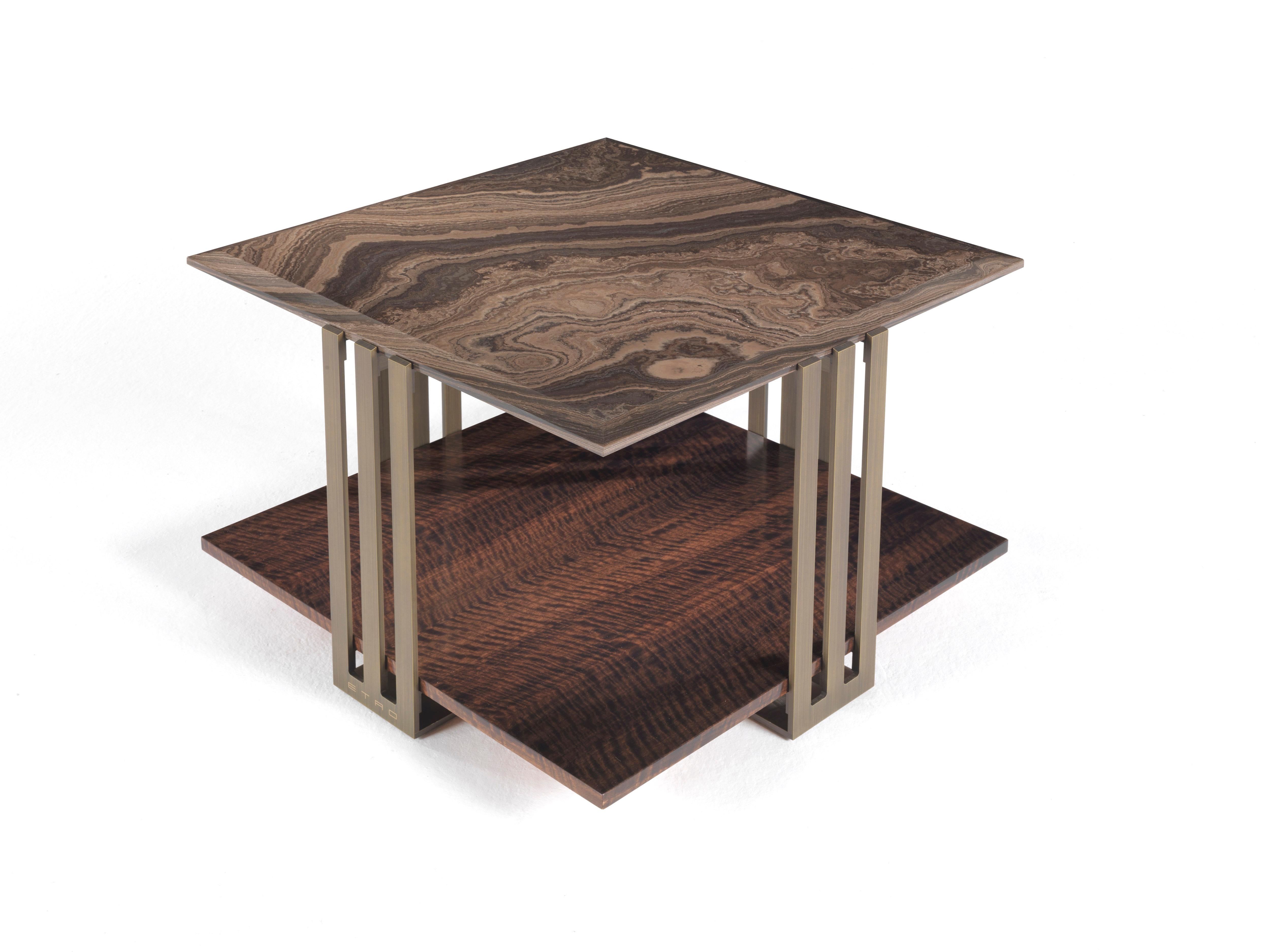 A compact two-tops small table featuring an original combination of materials. The structure in patinated bronze metal meets the precious elegance of the tops in marble or wood from the Etro Home Interiors collection, creating a precious and